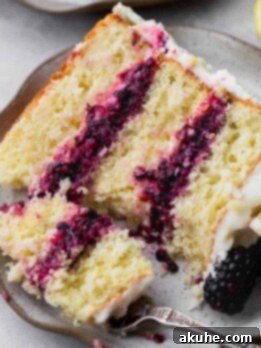 Zesty Lemon Blackberry Delight 15 Taking a fork out of the lemon blackberry cake.