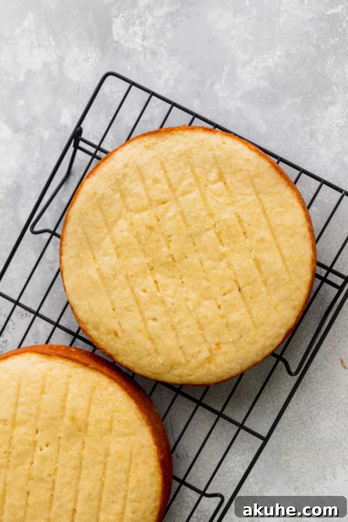 Zesty Lemon Blackberry Delight 6 A freshly baked lemon cake layer cooling on a wire rack.