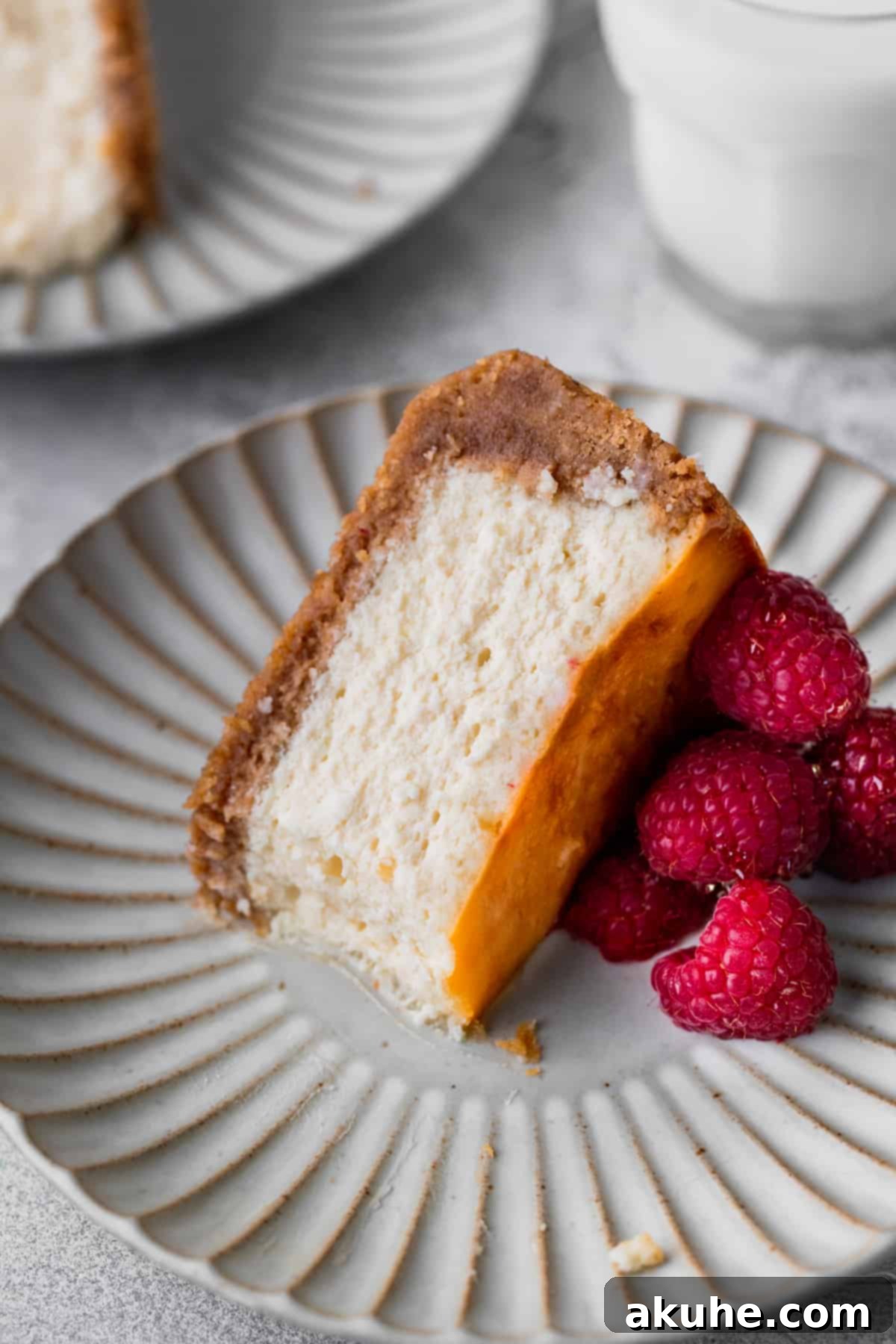 A delectable slice of honey cheesecake on its side, showing a bite taken out, highlighting its creamy texture.