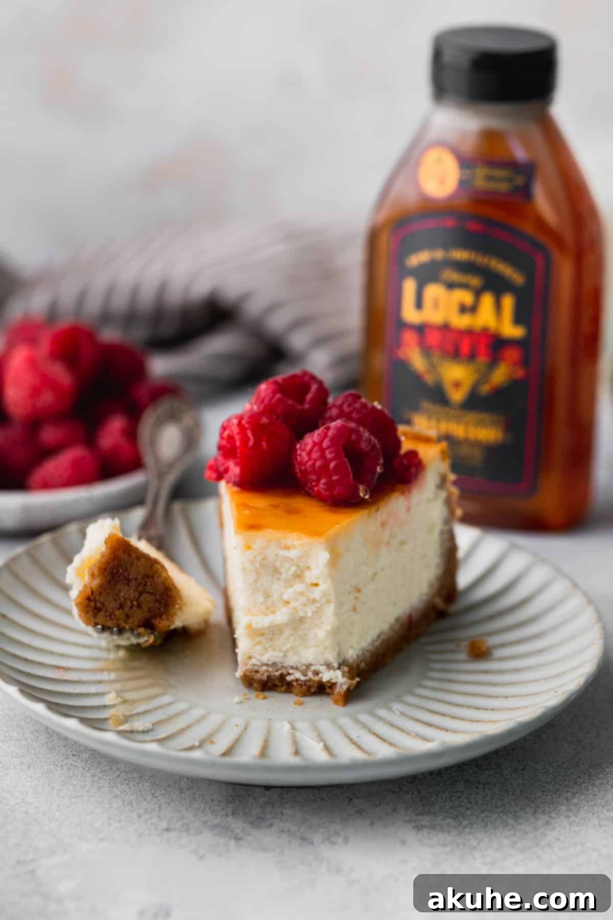 A single, perfectly portioned slice of honey cheesecake on a plate, ready to be enjoyed.