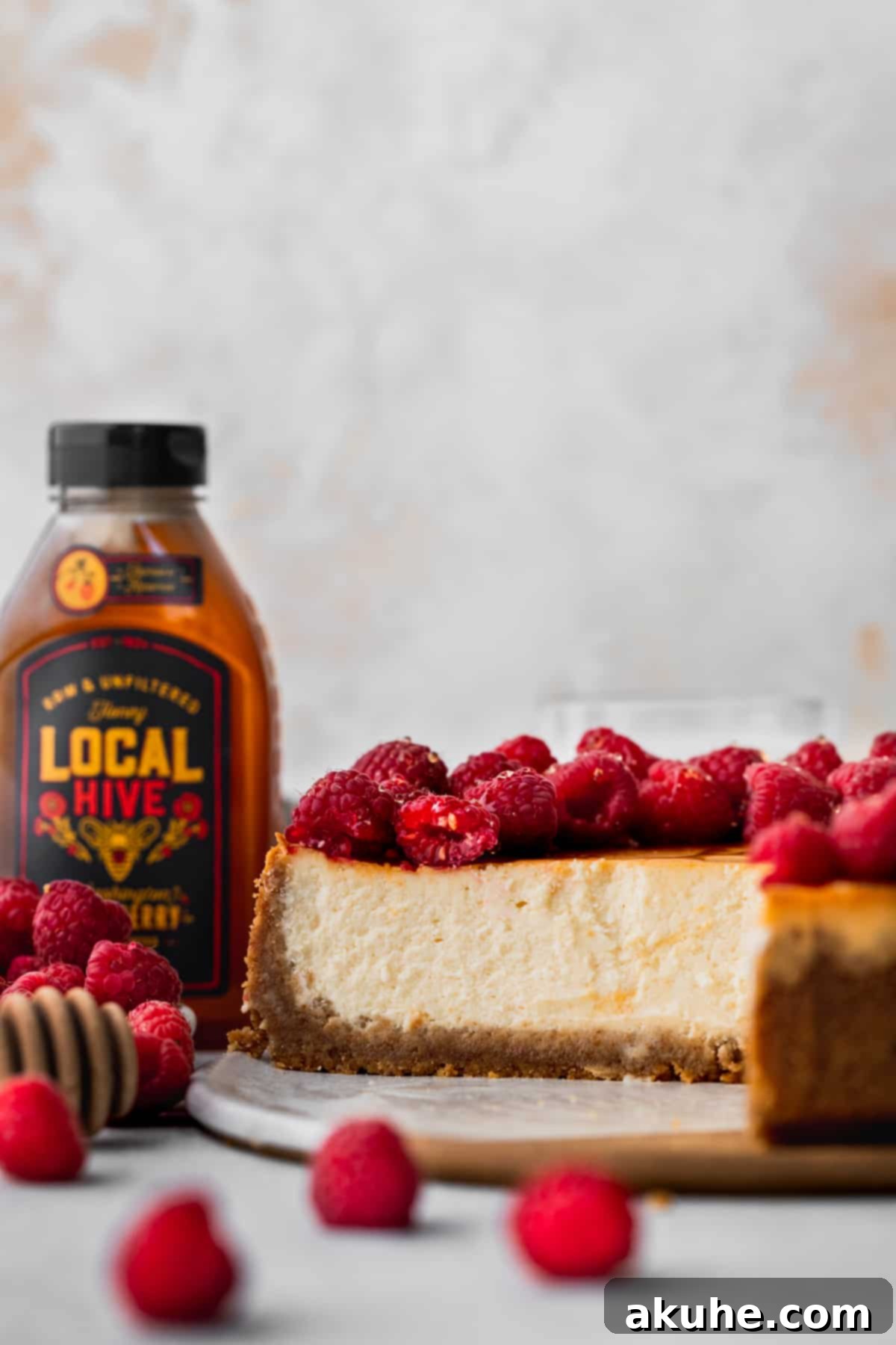 Side view of a perfectly baked and chilled honey cheesecake, showing its smooth edges.