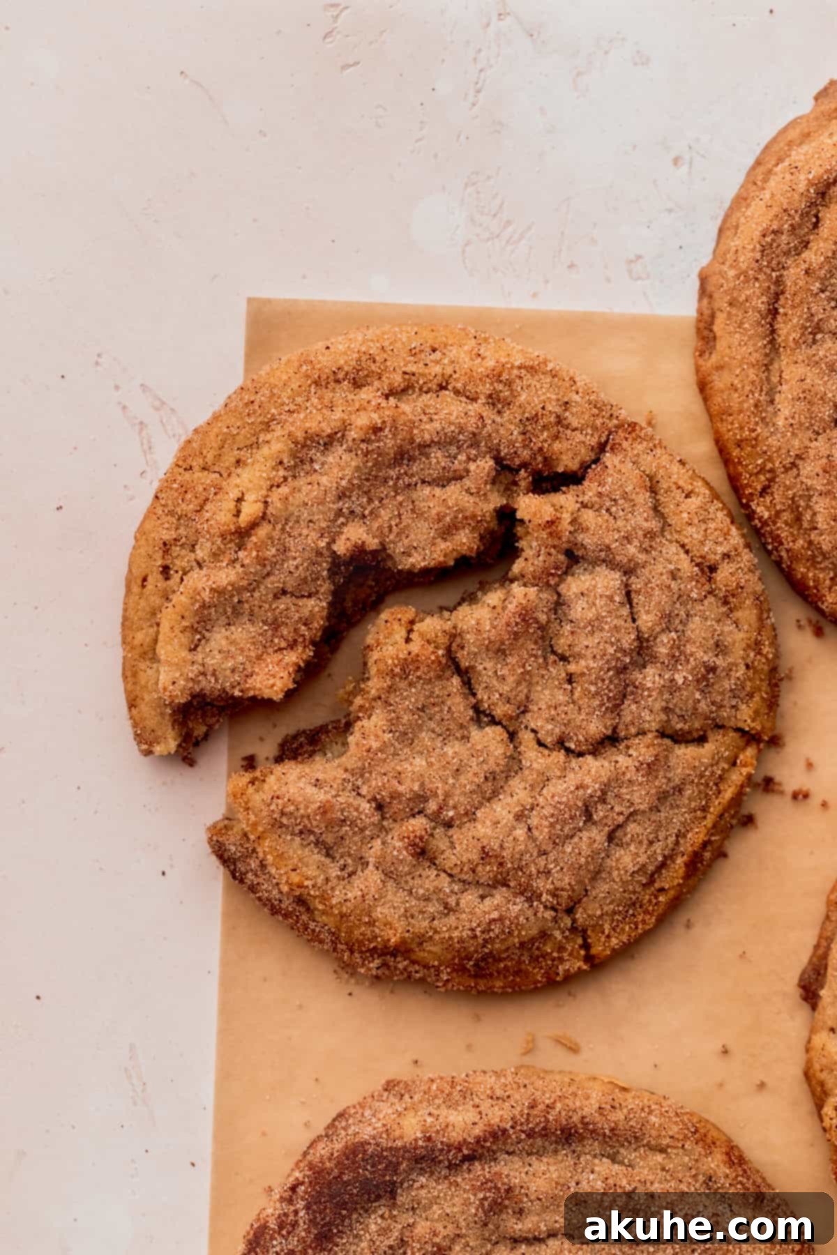 Snickerdoodle Peanut Butter Bliss 3 One peanut butter cookie split in half, revealing its chewy center.