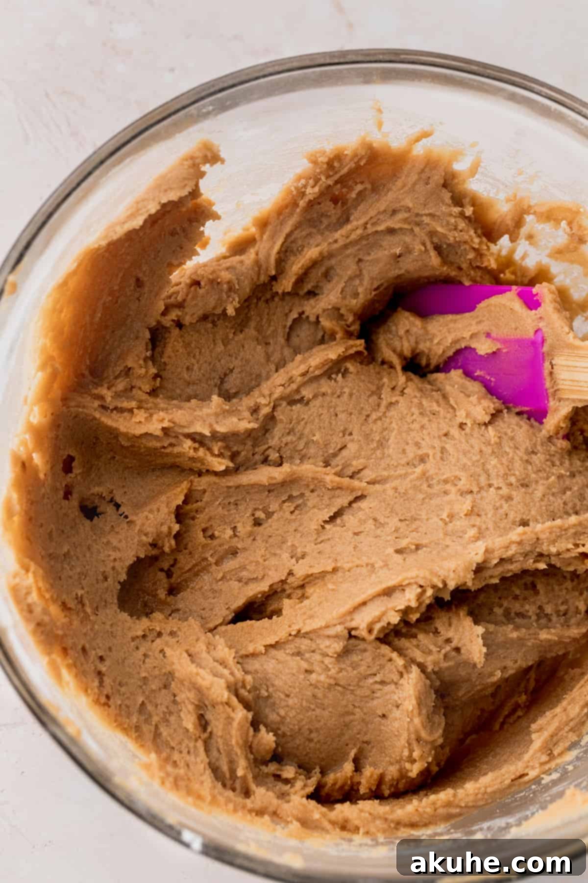 Snickerdoodle Peanut Butter Bliss 5 Cookie dough in a glass bowl after dry ingredients have been mixed in.