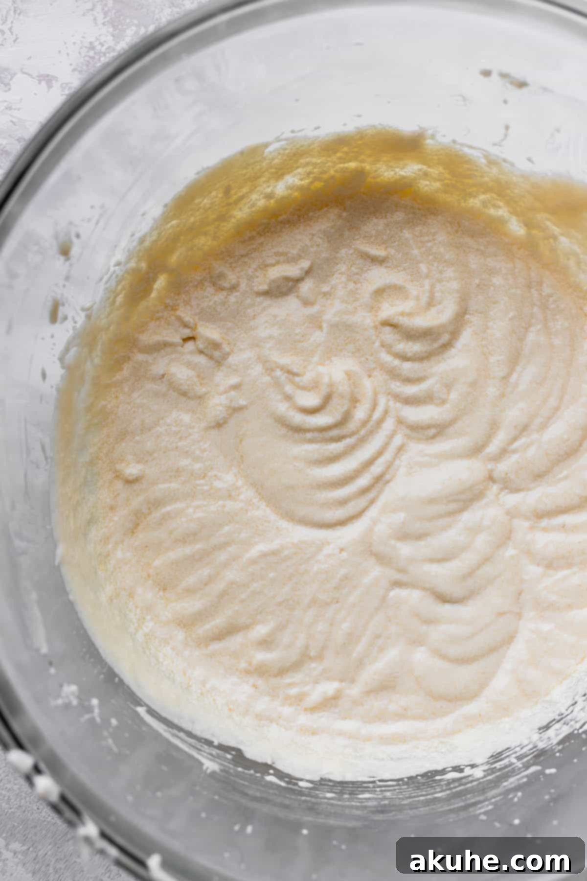 Vanilla Bean Mini Cakes 5 A bowl of wet ingredients, including sour cream and vanilla, mixed and ready for the next step.