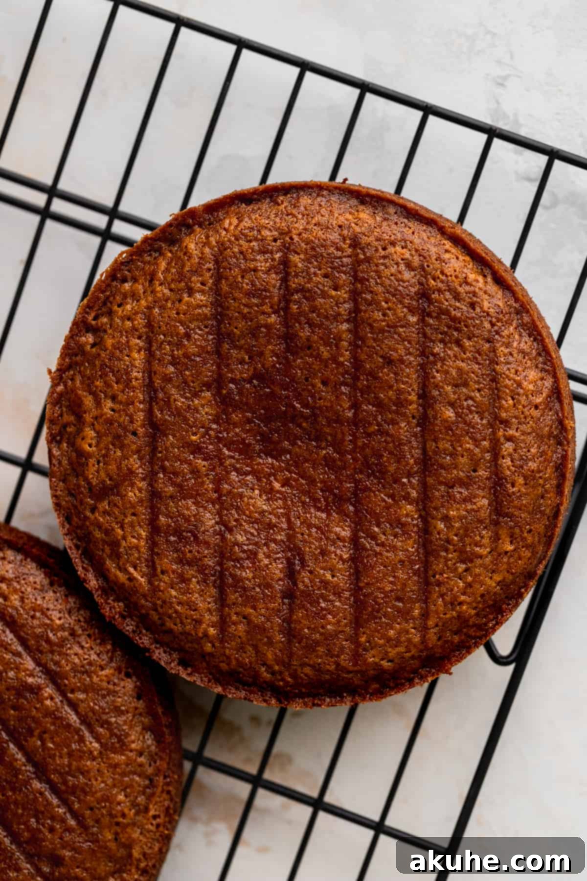 Baked cake layers cooling on a wire rack.