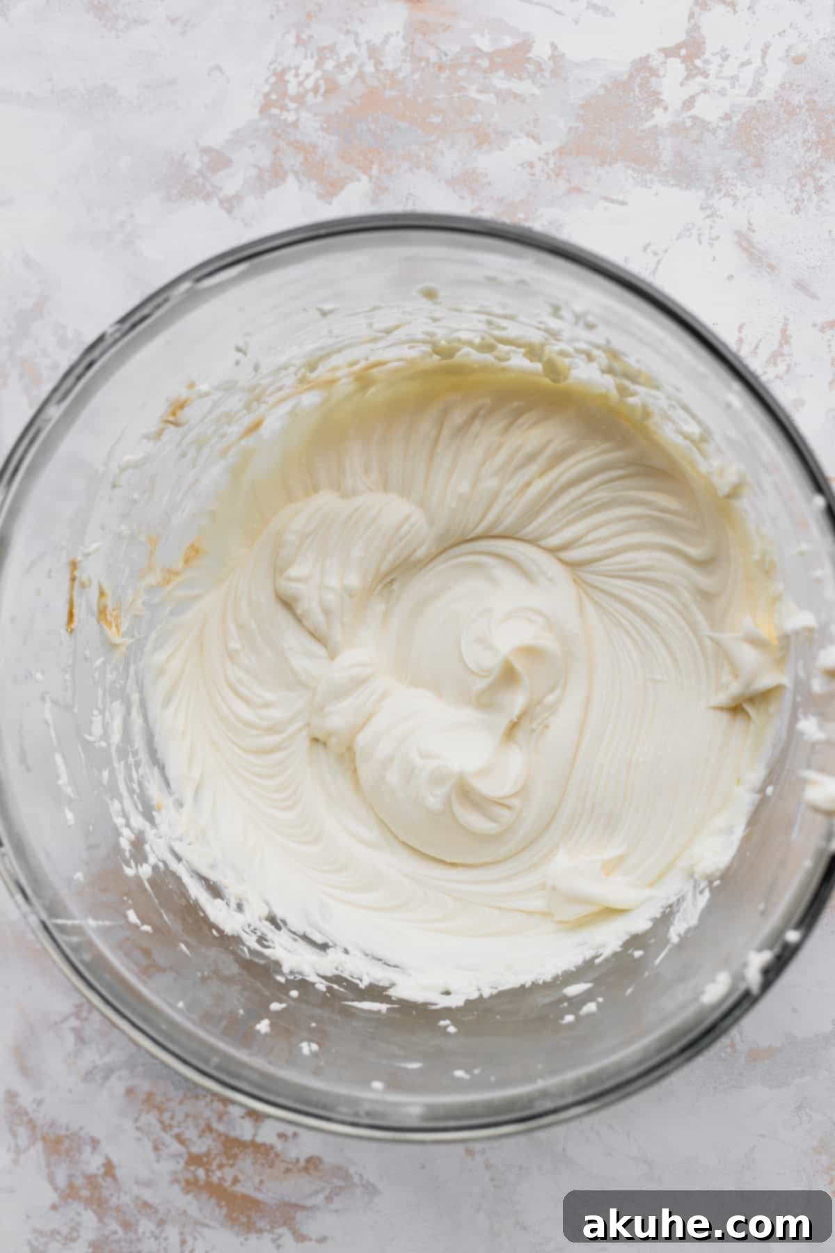 Decadent Oreo Cheesecake Brownies 4 Cream cheese batter in a glass bowl.