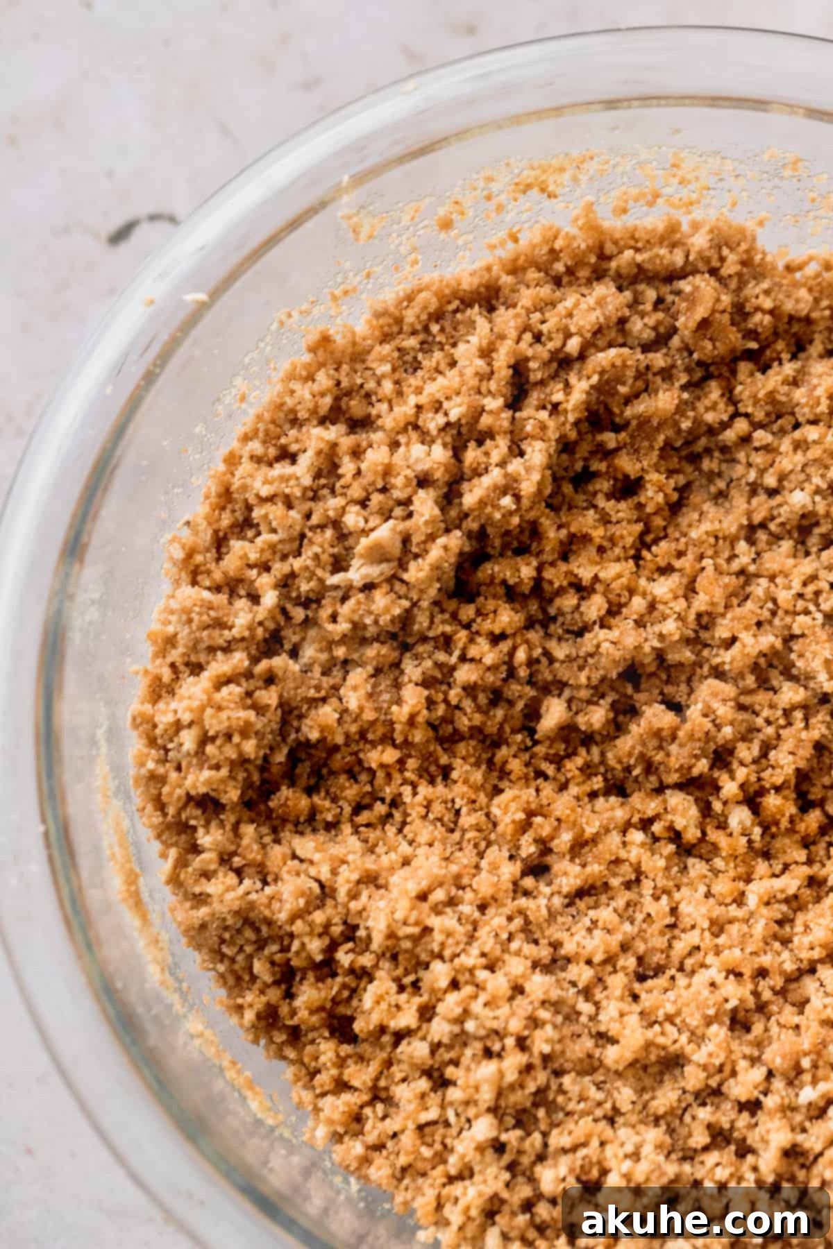 Whimsical Easter Egg Cheesecake 4 Graham cracker crumbs in a glass bowl.