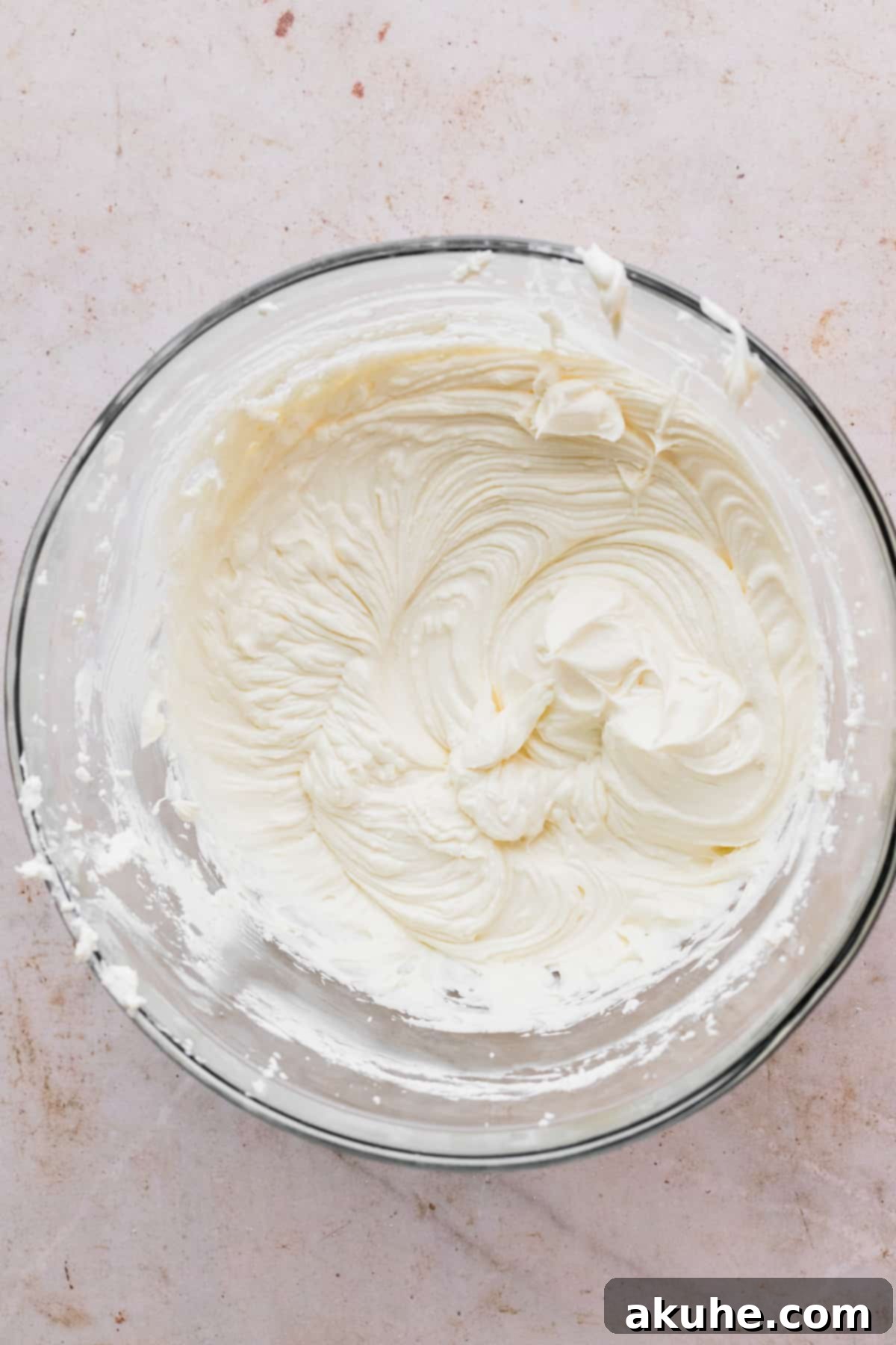 Whimsical Easter Egg Cheesecake 7 Cream cheese and sugar beaten in a glass bowl.