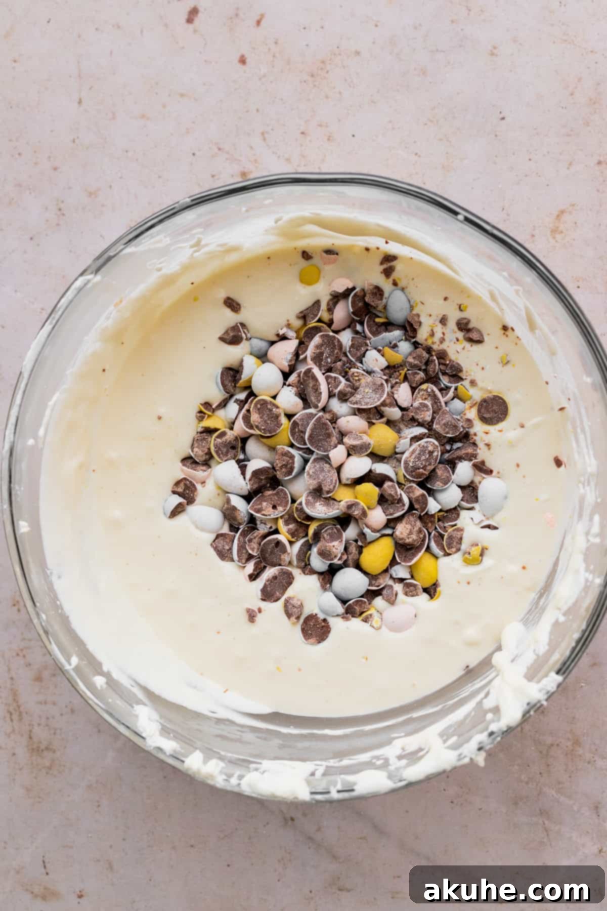 Whimsical Easter Egg Cheesecake 8 Cheesecake batter with chopped mini eggs on top.