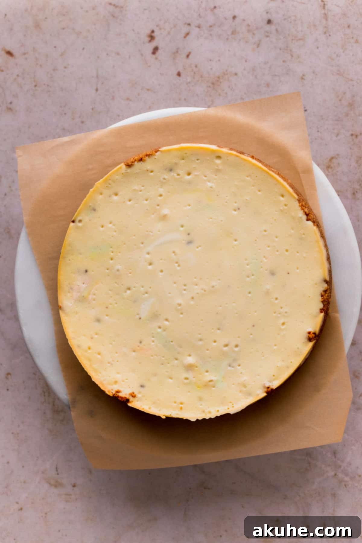 Whimsical Easter Egg Cheesecake 10 Baked cheesecake on top of a cake stand.