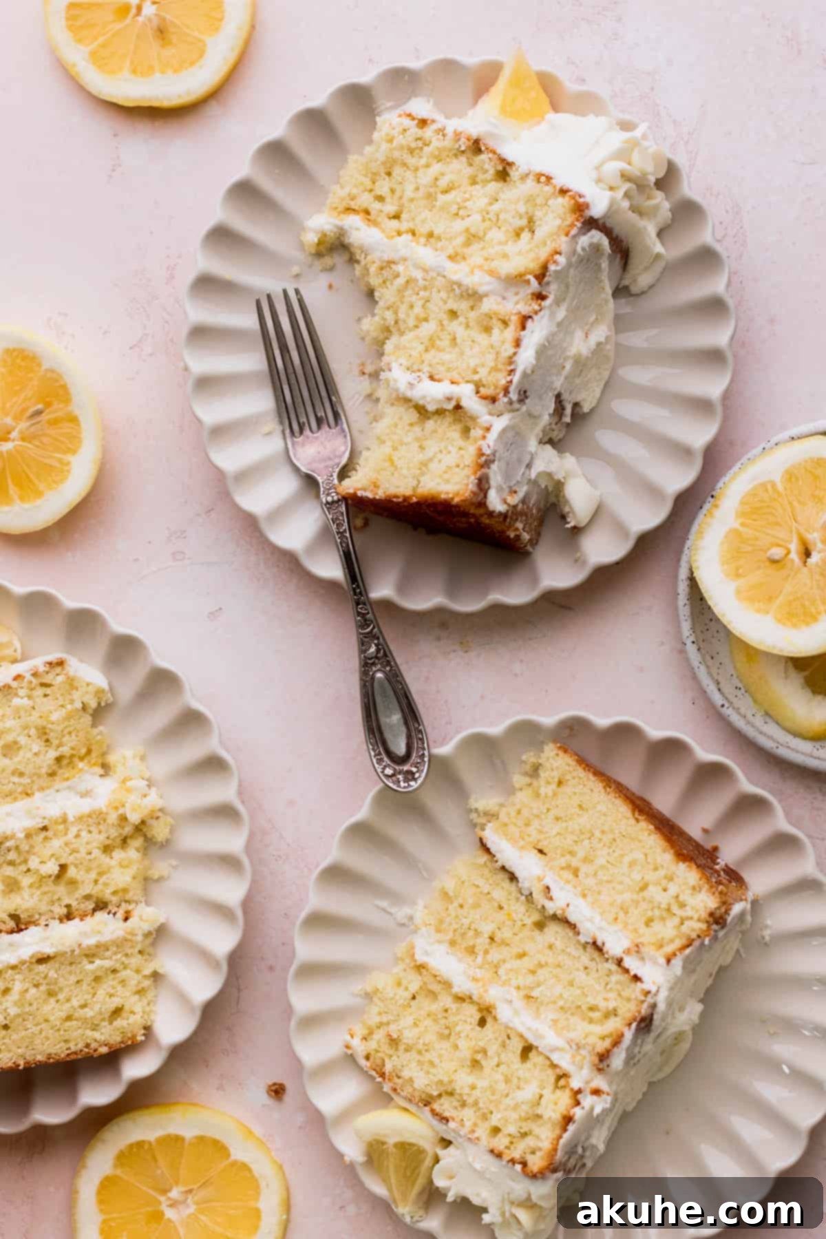 Decadent Lemon White Chocolate Bliss 12 Three individual slices of Lemon White Chocolate Cake, each on its own plate, ready to be served.