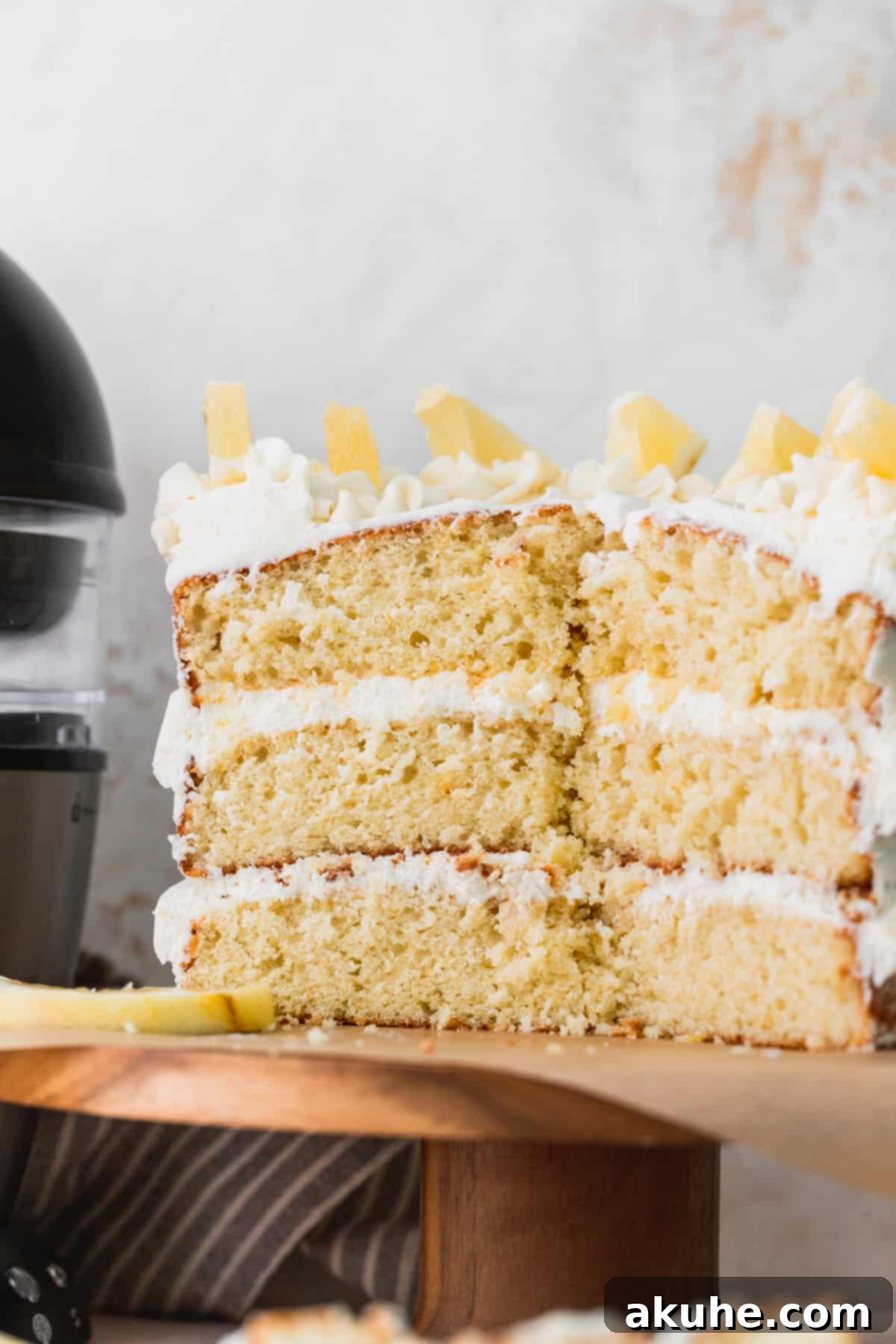 Decadent Lemon White Chocolate Bliss 3 A close-up view of a baked lemon cake layer, expertly split in half to reveal its tender, uniform crumb and golden hue.