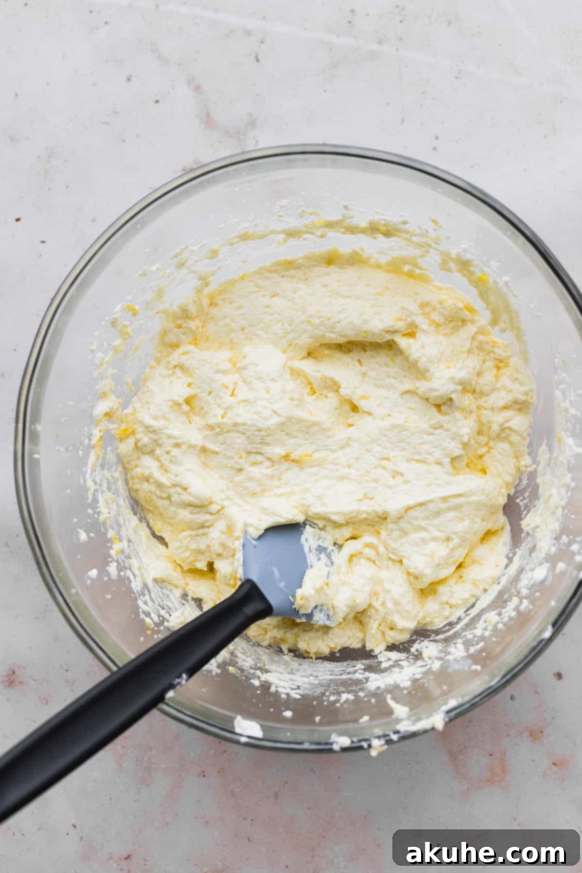 Decadent Lemon White Chocolate Bliss 5 A mixing bowl filled with wet ingredients for the cake batter, showing a smooth and creamy consistency.