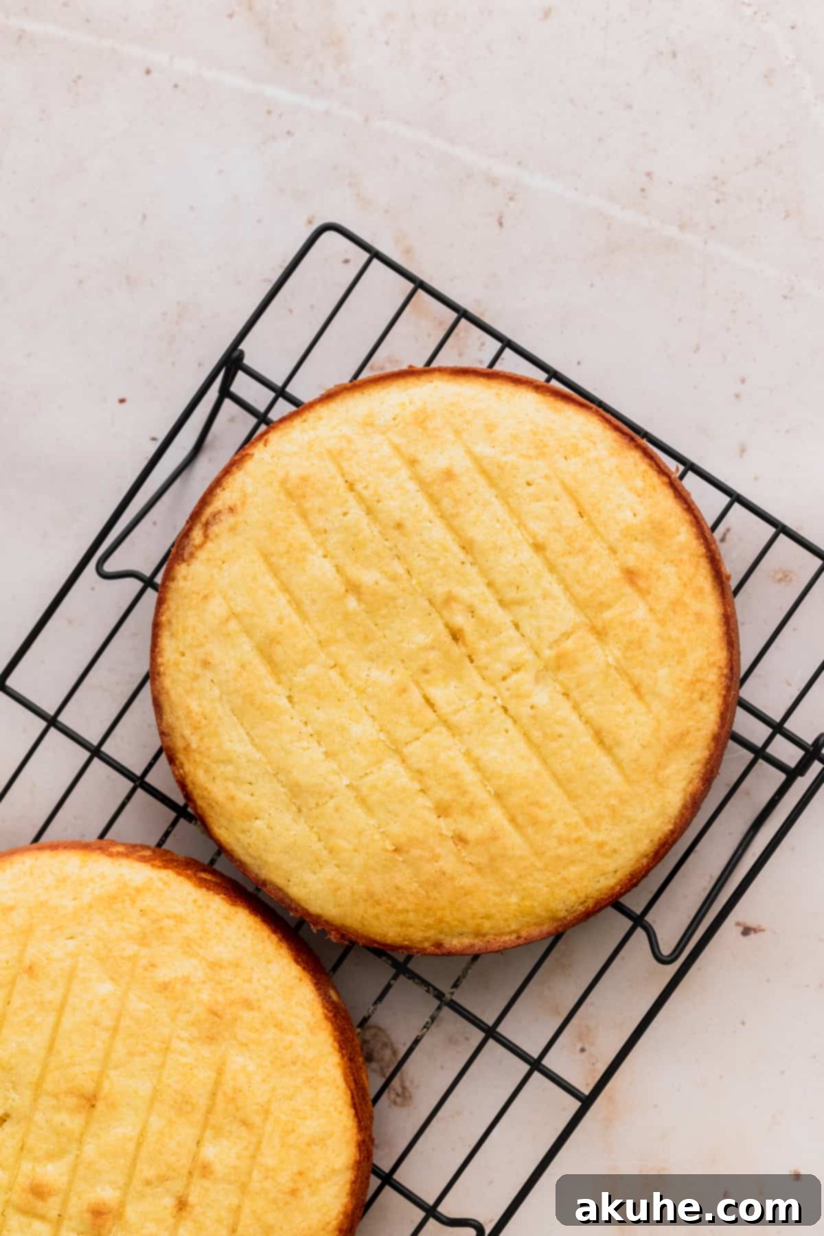 Decadent Lemon White Chocolate Bliss 7 Freshly baked lemon cake layers cooling on a wire rack, ready for frosting.