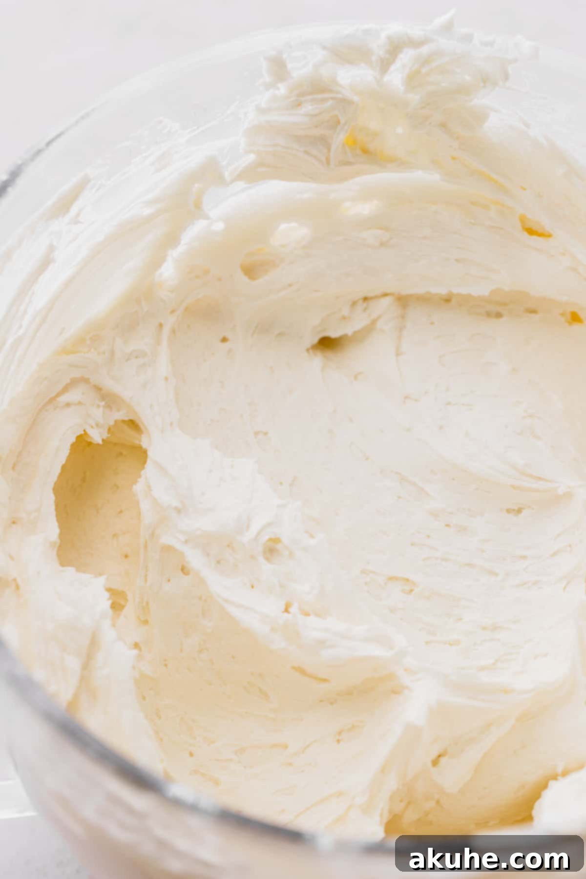 Decadent Lemon White Chocolate Bliss 9 A close-up of luscious white chocolate frosting, rich and creamy, perfect for decorating a cake.