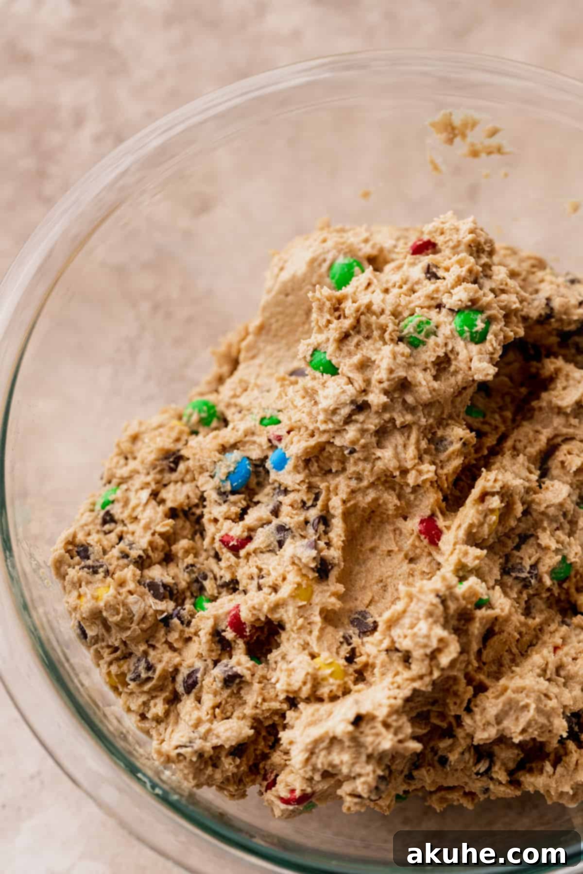 Soft, peanut butter-infused cookie dough ready for shaping, showcasing its delicious texture in a glass bowl.