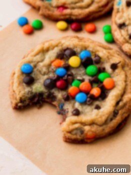 A bite missing from one mini M&M cookie.