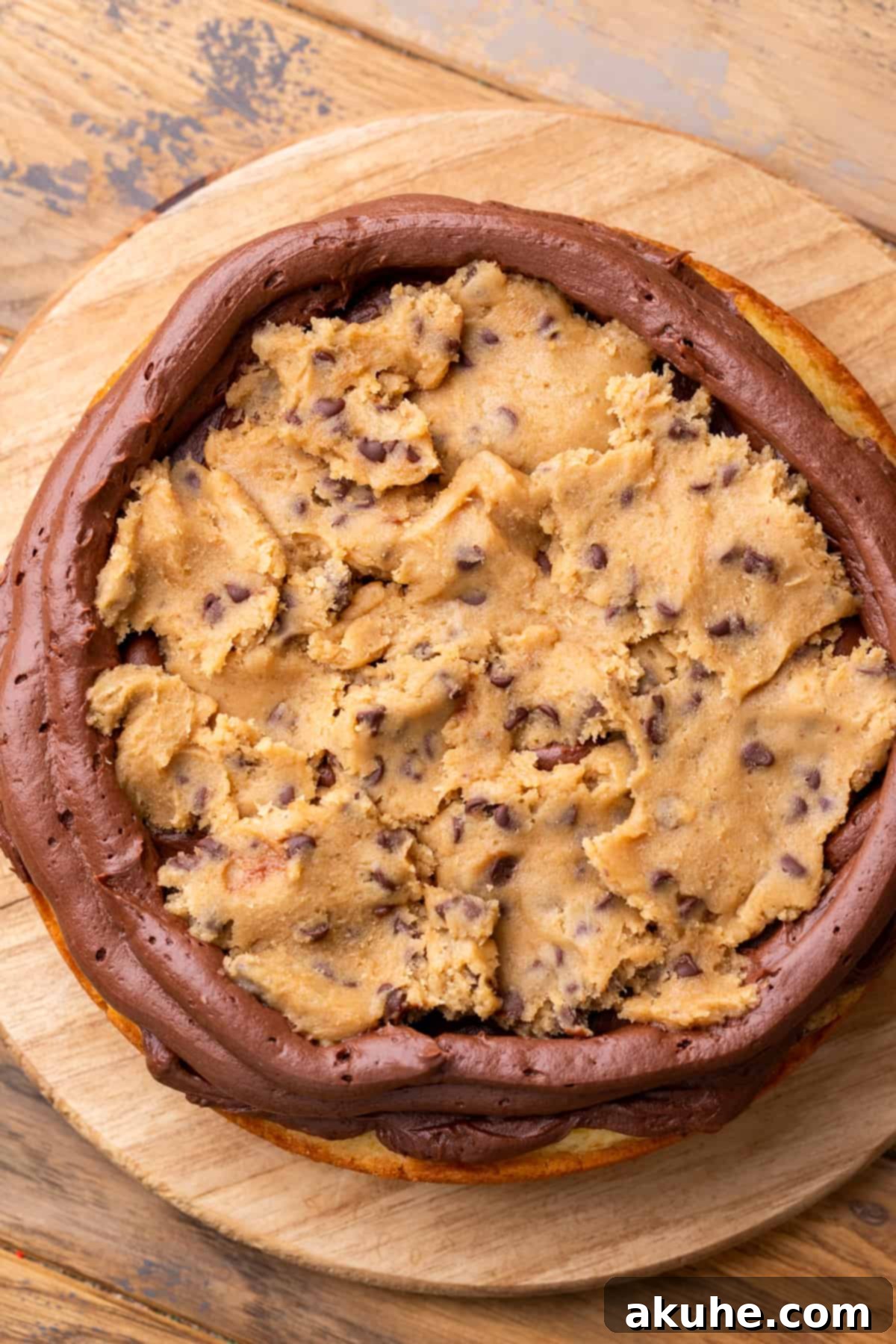 Decadent Cookie Dough Cake 11 Close-up of a cake layer with chocolate cream cheese frosting and a generous filling of edible cookie dough.