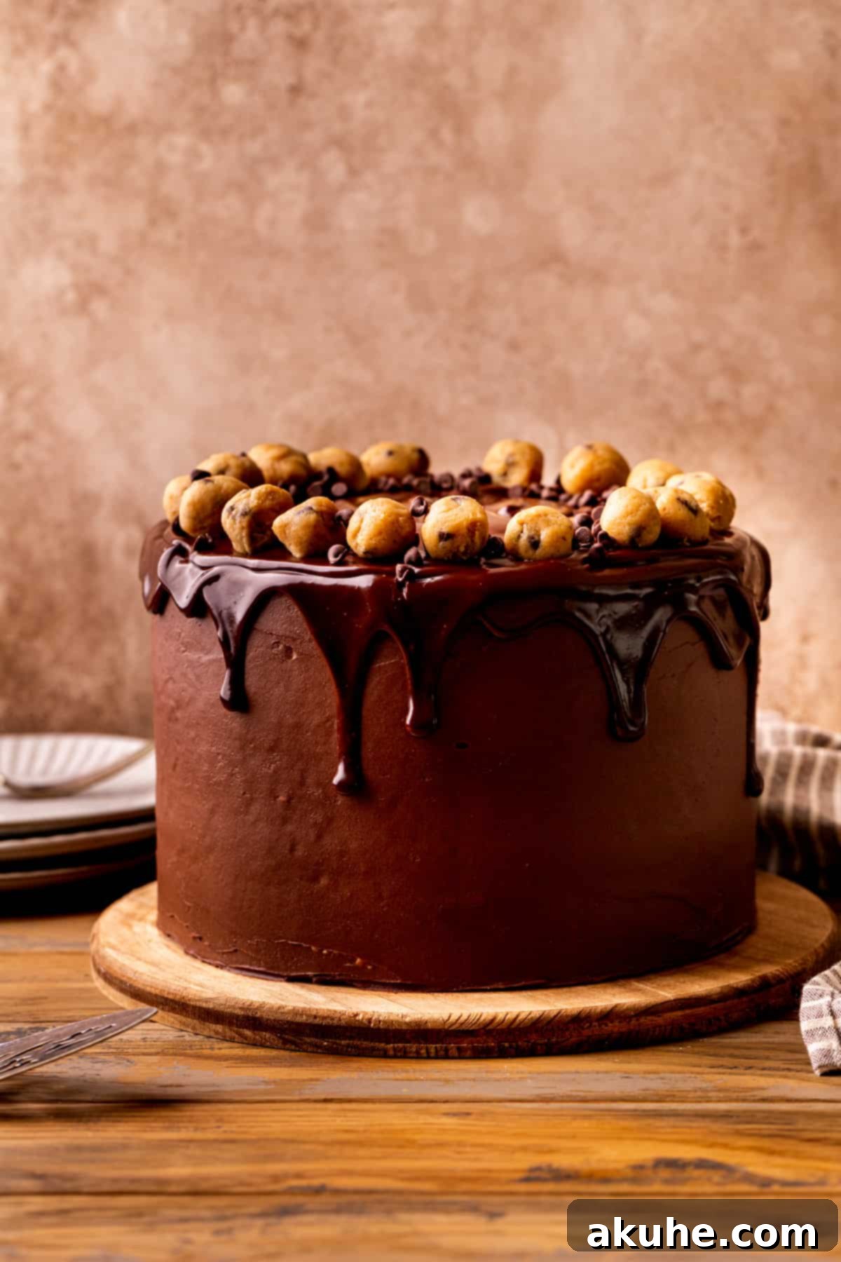 Decadent Cookie Dough Cake 12 A beautifully decorated Cookie Dough Dream Cake on a white platter, showcasing the chocolate ganache drip and edible cookie dough topping.