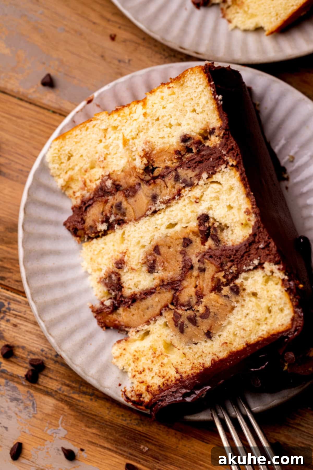 Decadent Cookie Dough Cake 3 A freshly baked slice of Cookie Dough Dream Cake, served on a white plate, showcasing its soft textures and delicious layers.