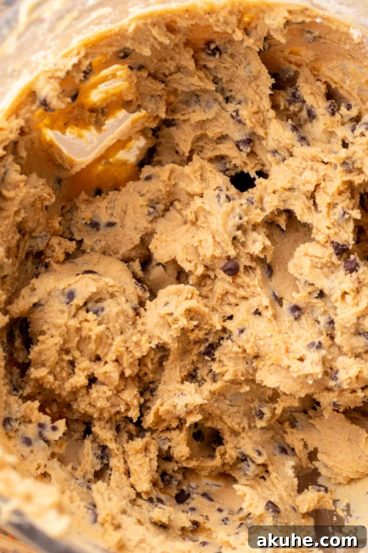 Decadent Cookie Dough Cake 4 Freshly mixed edible cookie dough in a clear glass bowl, ready for shaping.