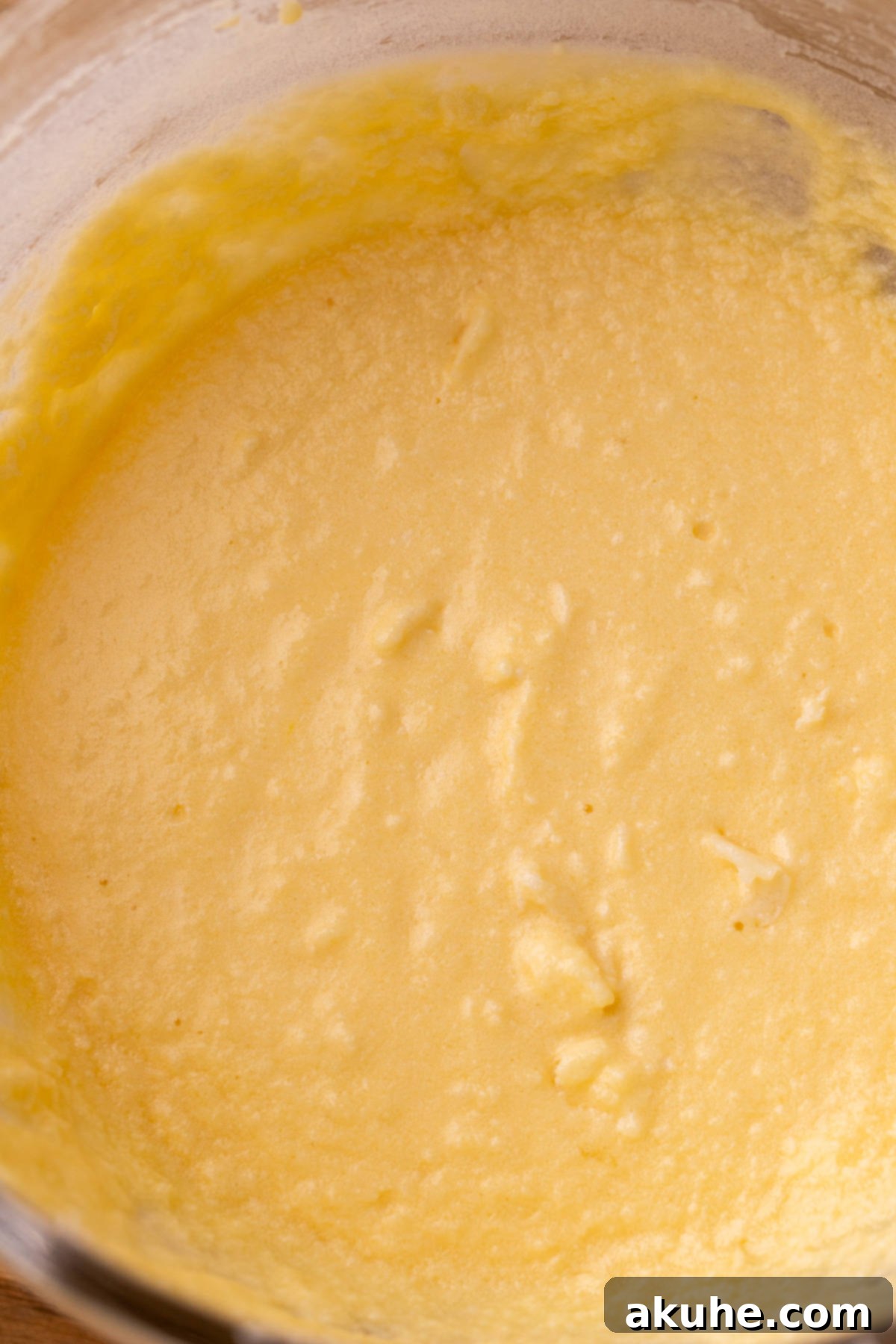 Decadent Cookie Dough Cake 6 A glass bowl filled with the creamy, wet ingredients for the vanilla cake batter, prior to adding dry ingredients.