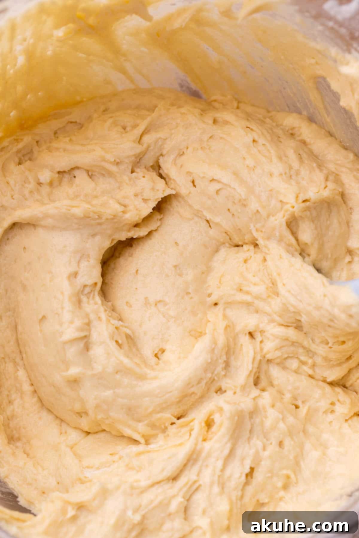 Decadent Cookie Dough Cake 7 Smooth and airy vanilla cake batter in a glass bowl, perfectly mixed and ready for the pans.