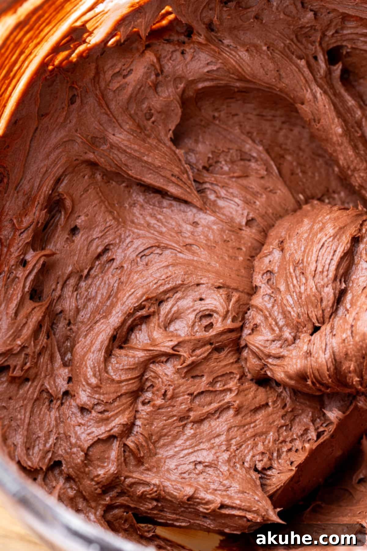 Decadent Cookie Dough Cake 10 A bowl of rich, creamy chocolate cream cheese frosting, perfectly whipped and ready to be used.