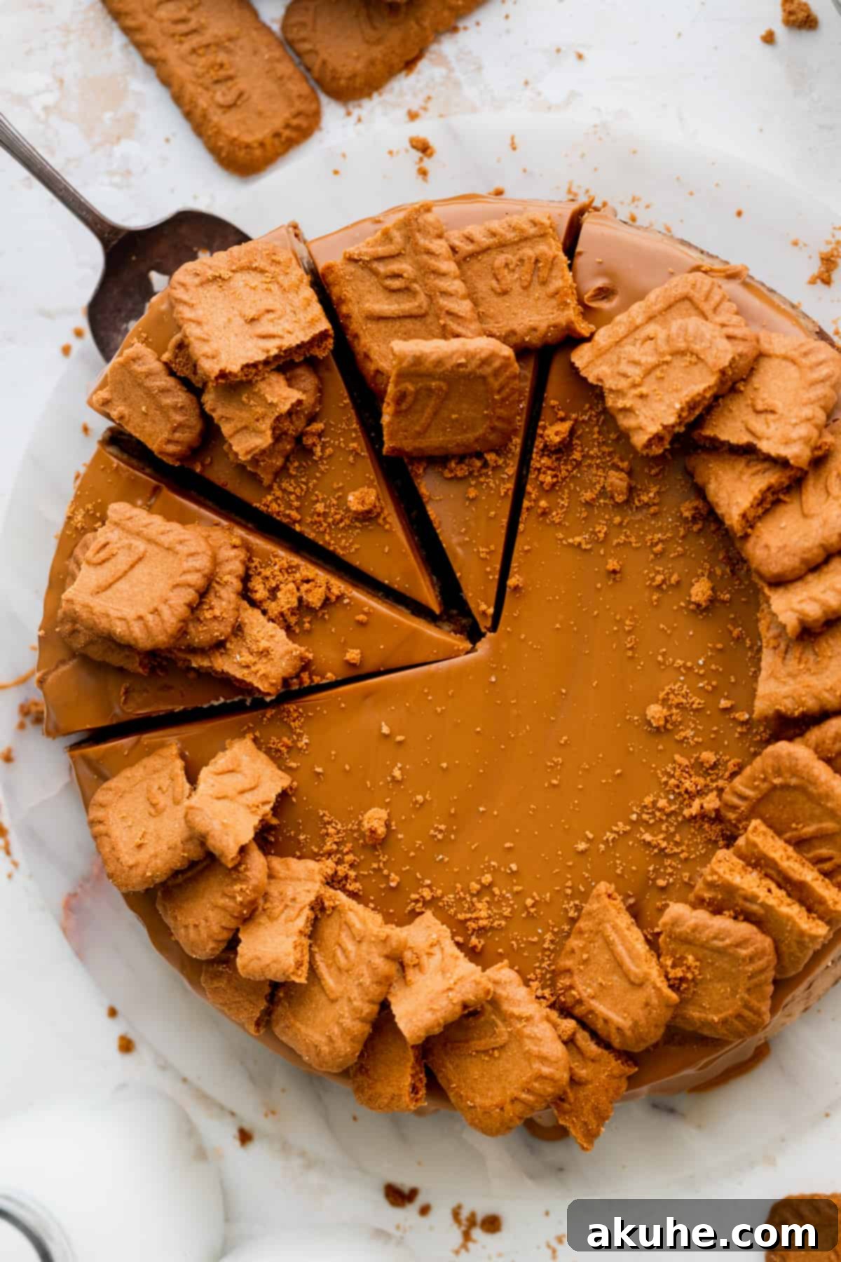 The Ultimate Biscoff Cheesecake 13 A close-up shot of a knife carefully removing a slice of Biscoff cheesecake, revealing the rich layers.