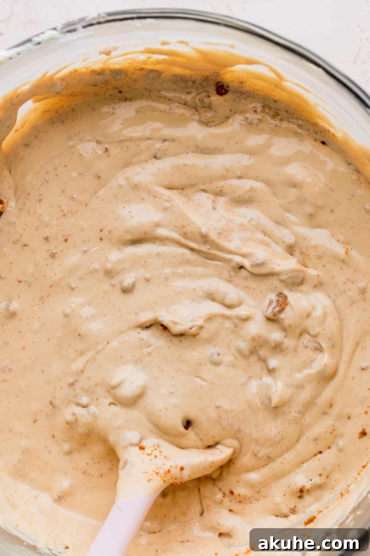The Ultimate Biscoff Cheesecake 8 Close-up of the smooth, creamy Biscoff cheesecake batter in a glass mixing bowl.