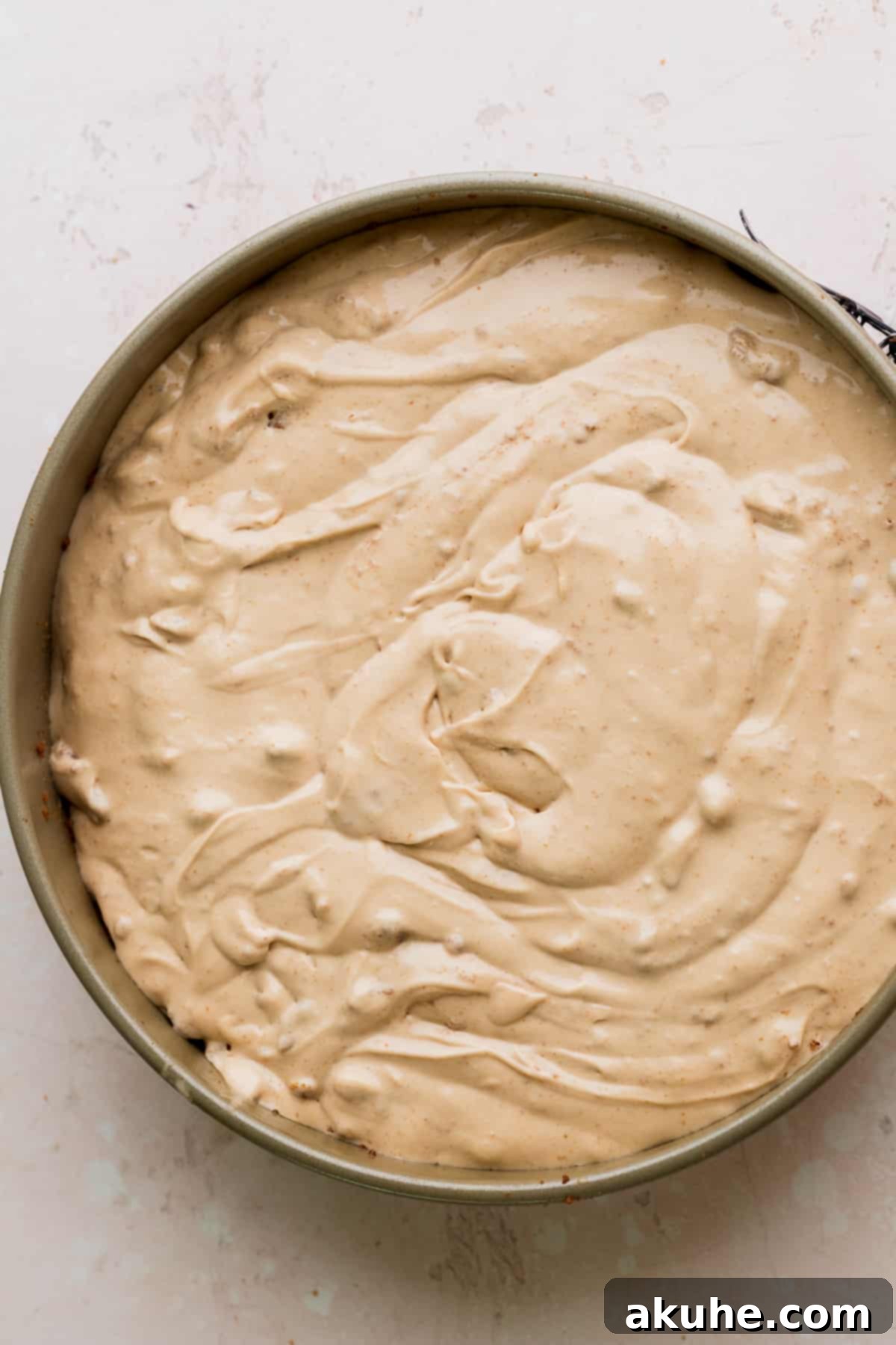 The Ultimate Biscoff Cheesecake 9 Smooth Biscoff cheesecake batter freshly poured into the springform pan, ready for baking.