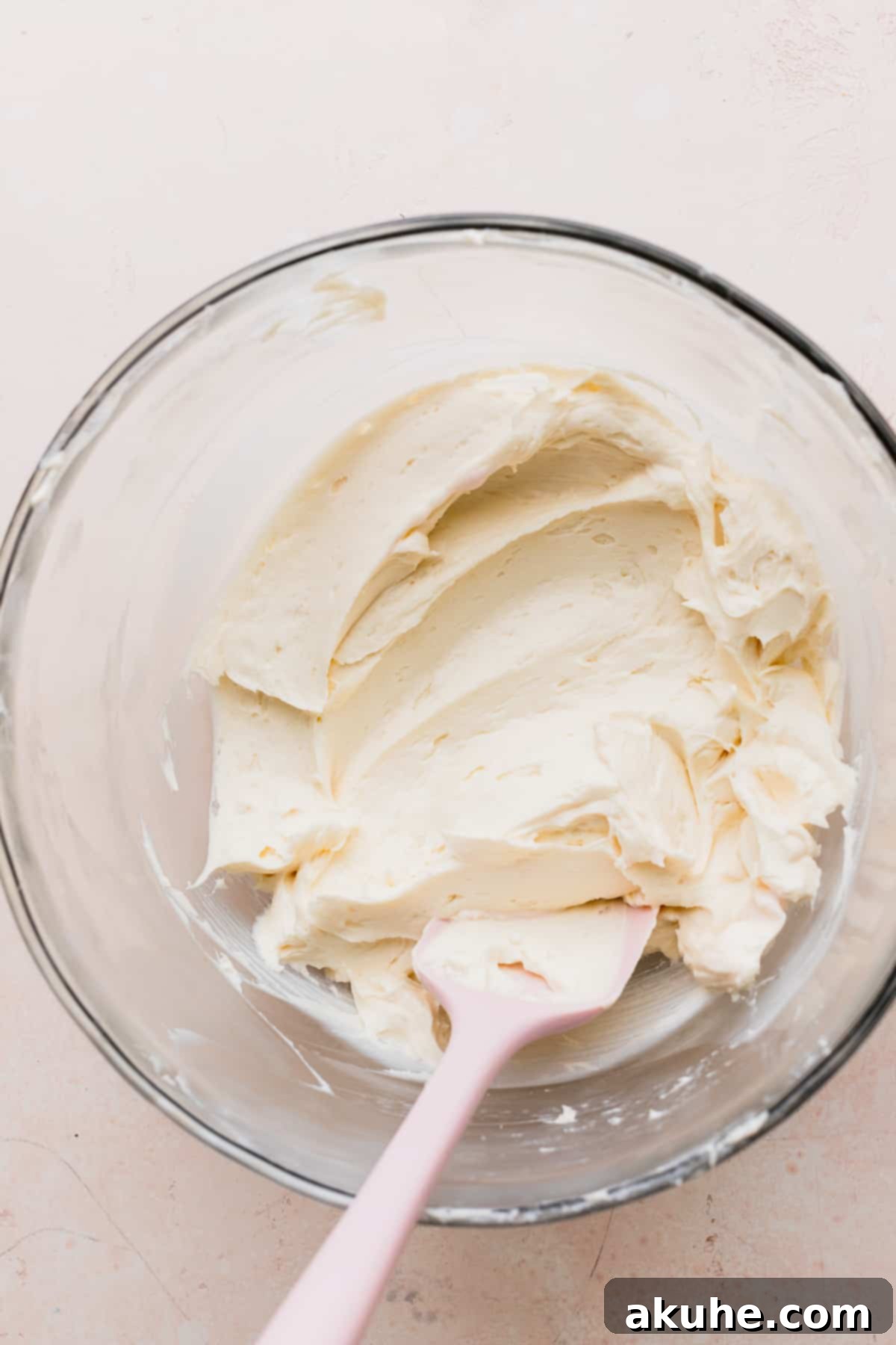 Smooth and creamy cream cheese mixture in a glass bowl, ready for ice cream.