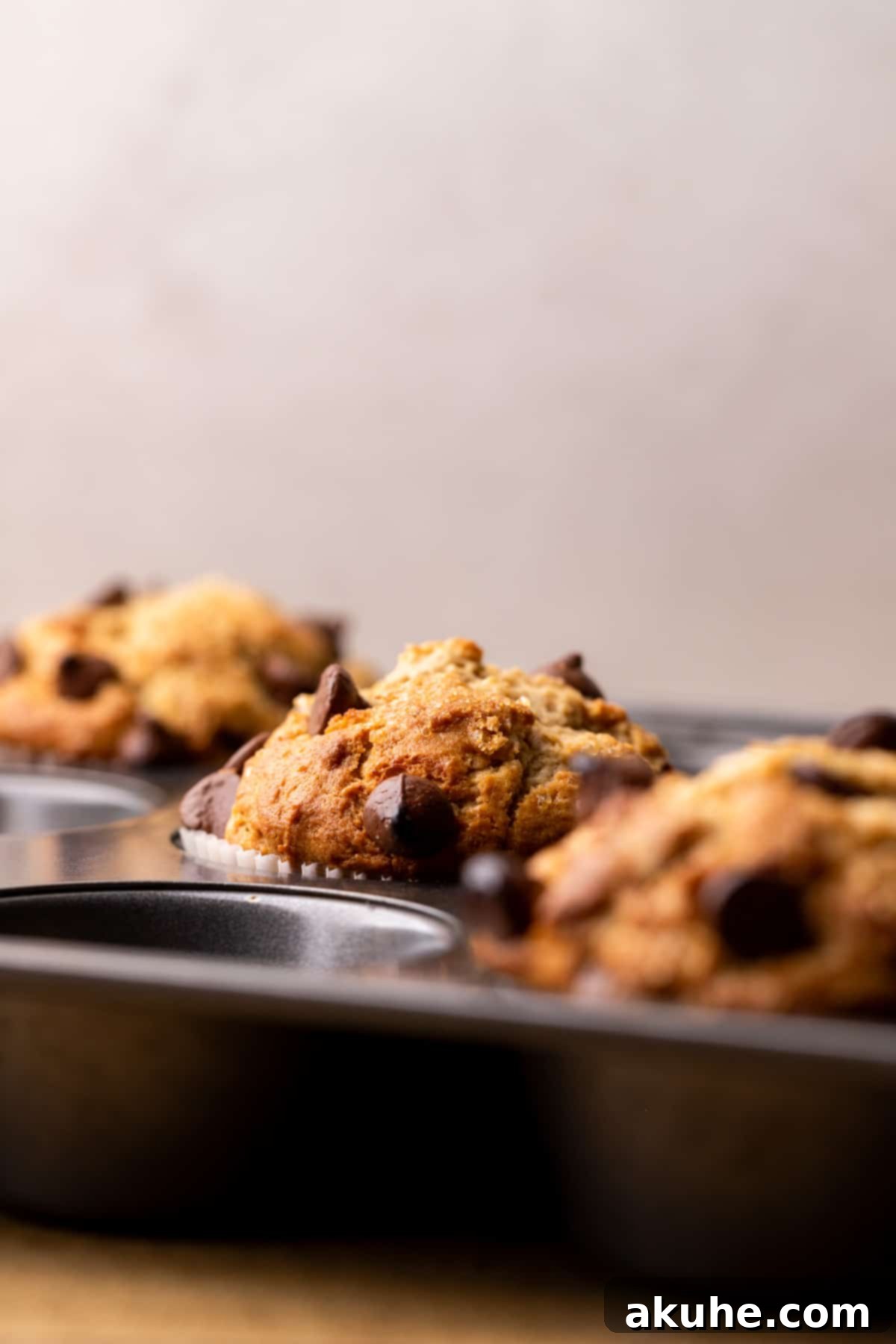 Ultimate Peanut Butter Banana Muffins 7 Baked muffins in a pan.