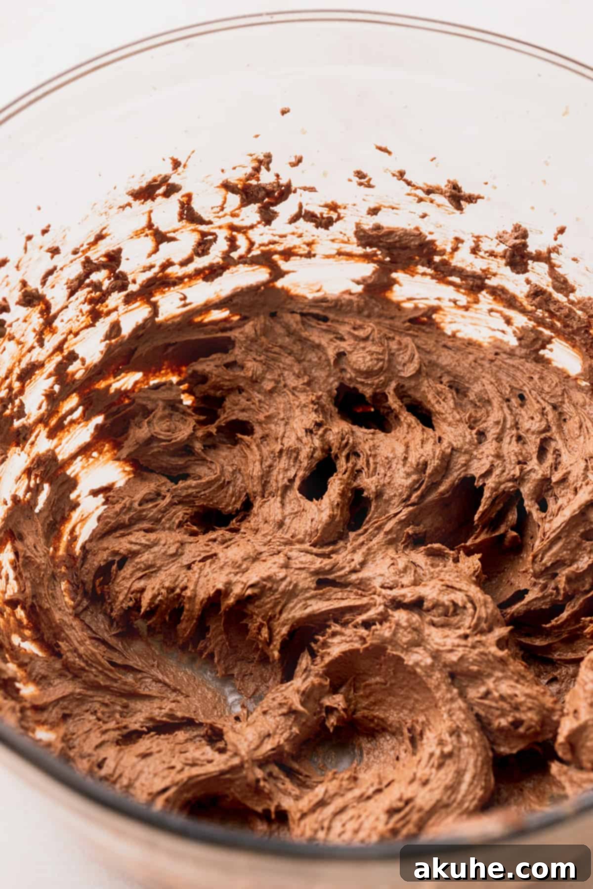 Ultimate Oreo Brookie Indulgence 7 Rich chocolate wet ingredients for brownie cookie dough in a glass bowl, beaten to perfection.