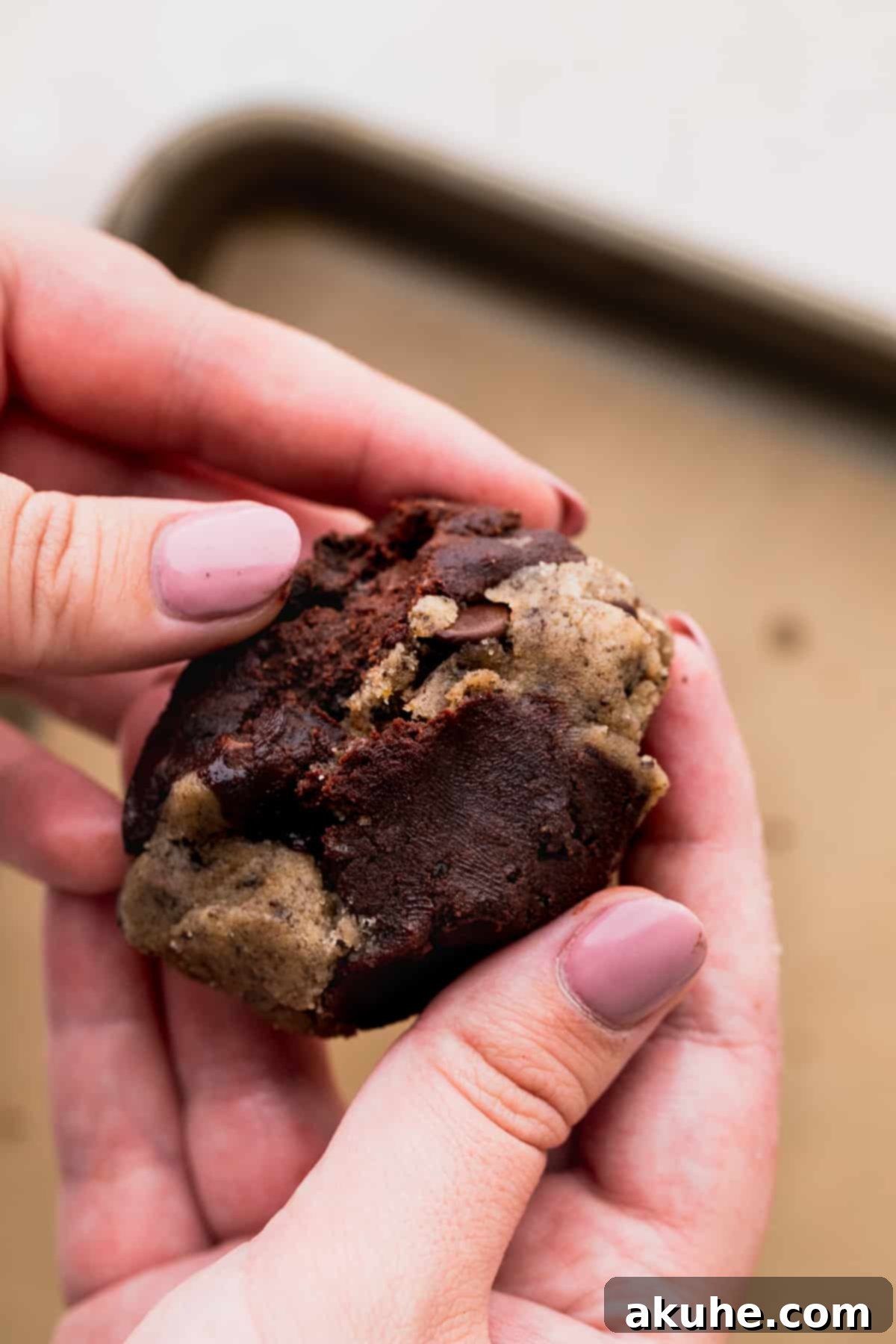 Ultimate Oreo Brookie Indulgence 10 Hands rolling together two different cookie doughs to create a swirled brookie.