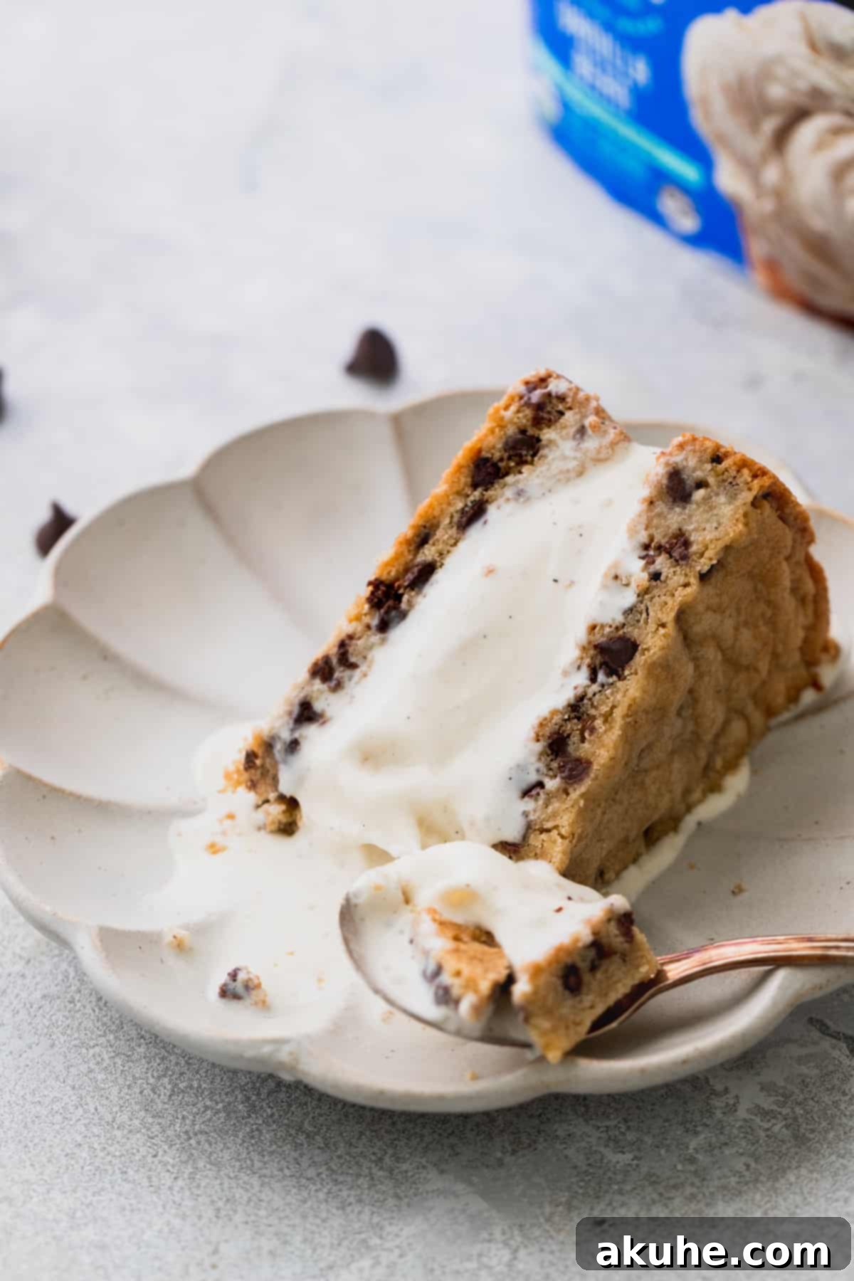 Decadent Cookie Sandwich 12 A spoon cutting into a delicious slice of the ice cream cookie sandwich on a plate.