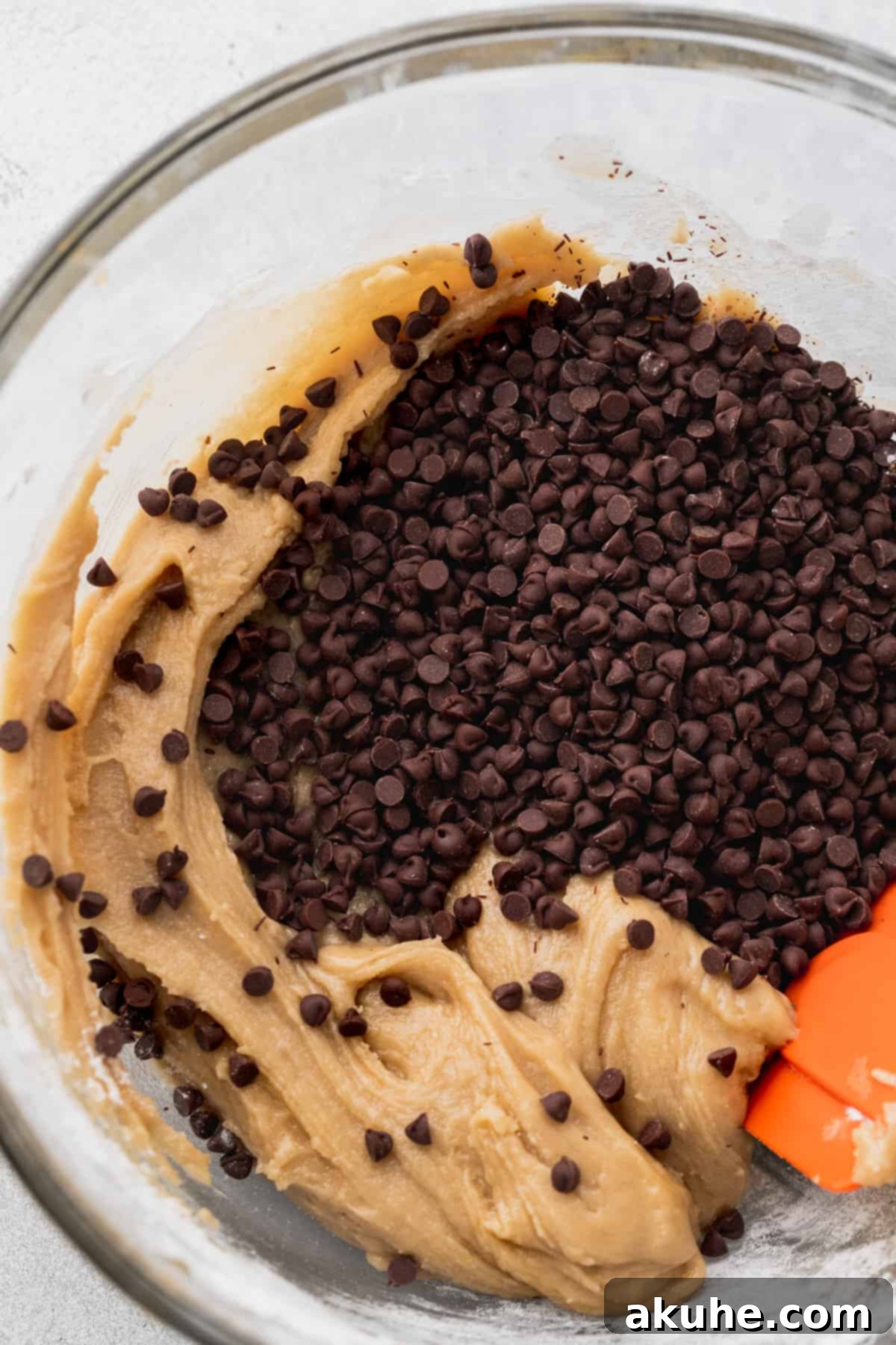 Decadent Cookie Sandwich 6 Mini chocolate chips sprinkled on top of cookie dough in a bowl.