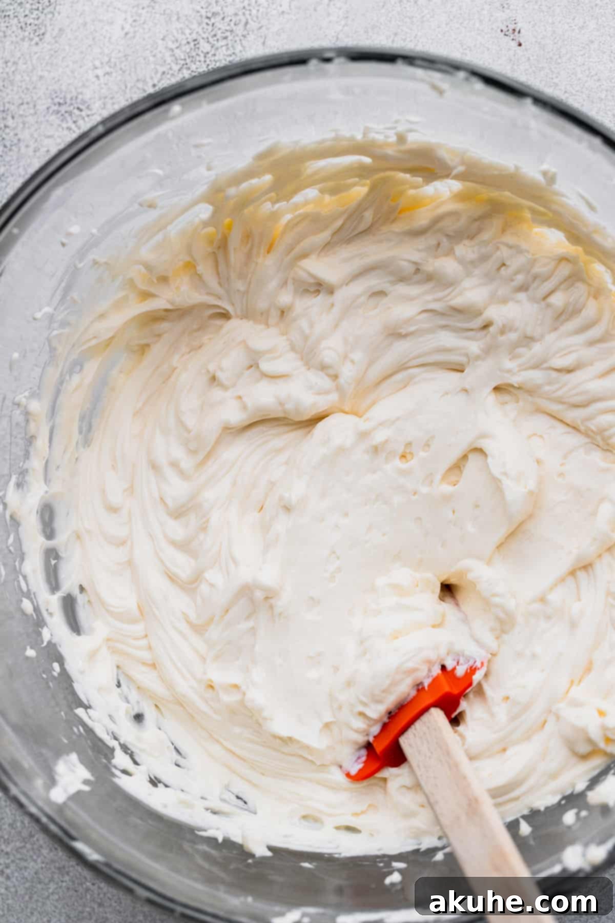 A vibrant bowl of wet cheesecake ingredients, smoothly mixed and ready for the next step in the preparation process.
