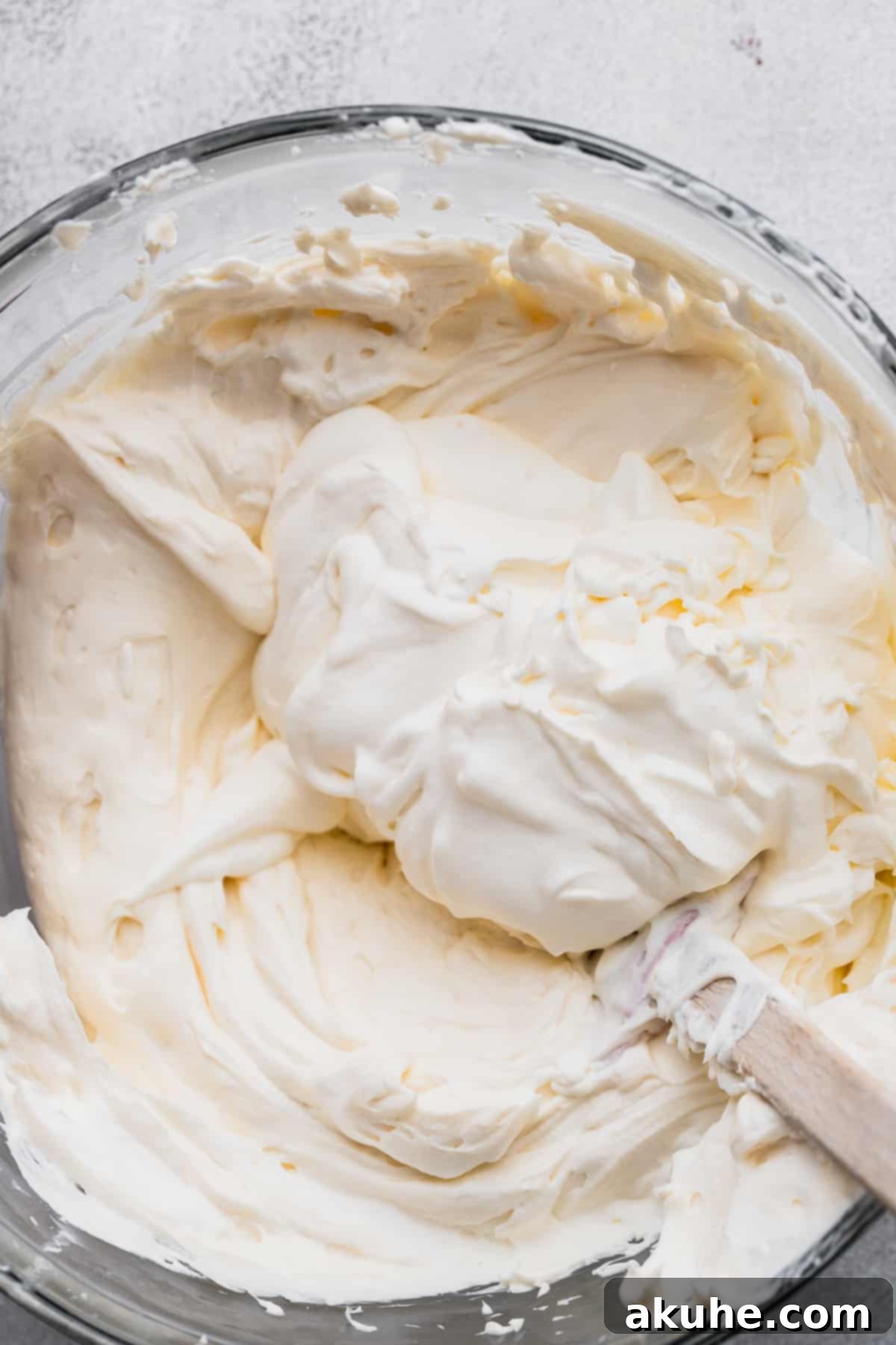 A generous dollop of freshly whipped cream gently folded into the luscious cheesecake batter, creating a harmonious blend of textures.