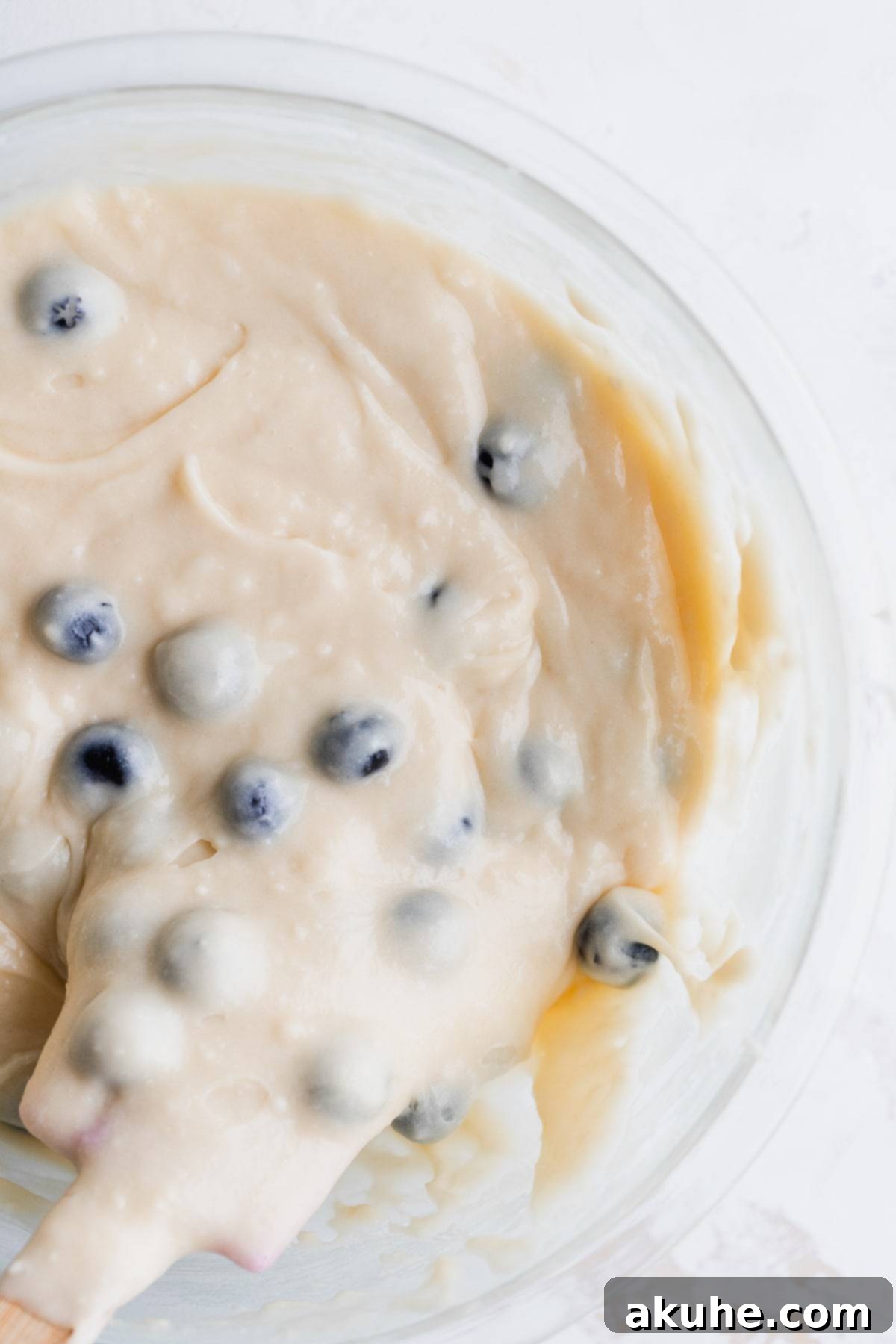 Giant Bakery Style Blueberry Muffins 5 Smooth, light-colored muffin batter in a glass bowl, ready for dry ingredients.