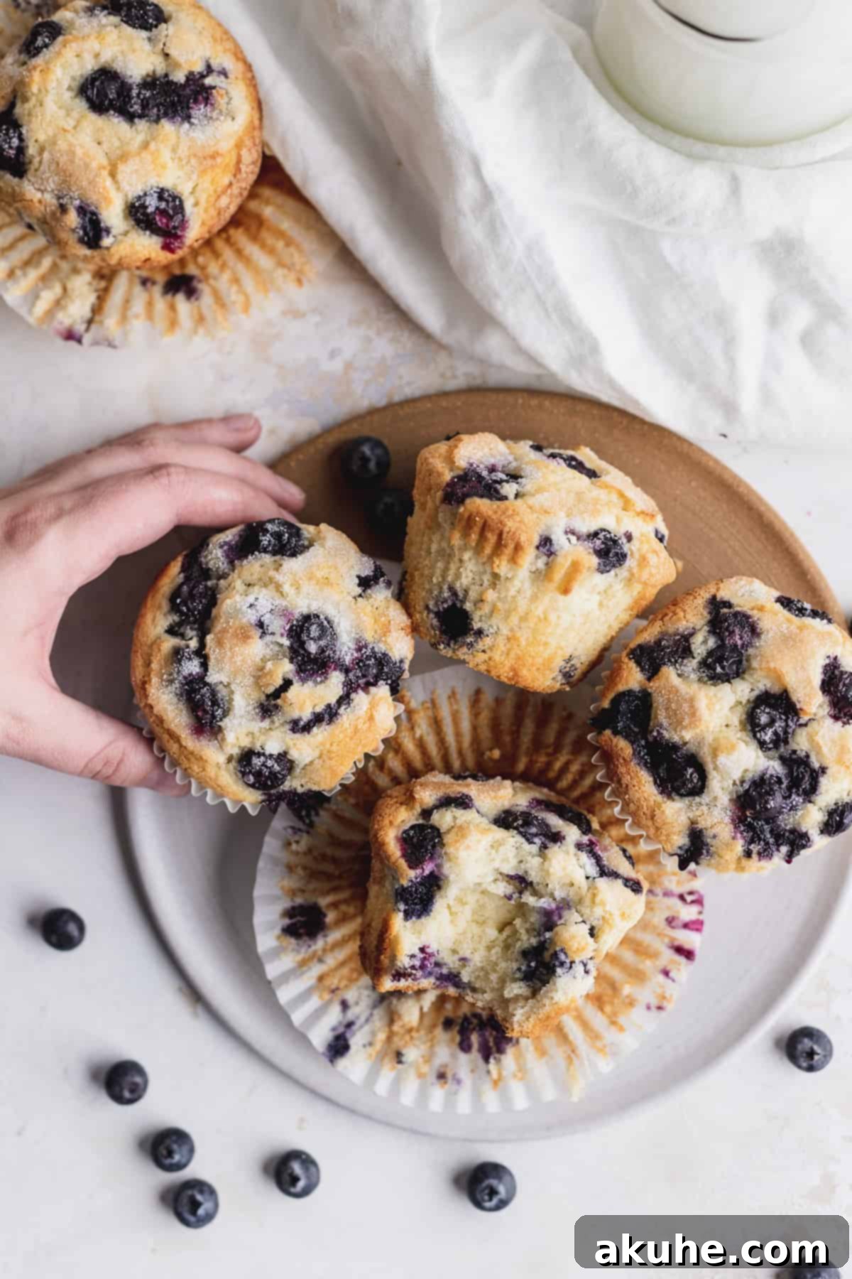 Giant Bakery Style Blueberry Muffins 11 A platter of freshly baked jumbo blueberry muffins, beautifully golden and ready to be enjoyed.