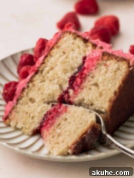 One slice of vanilla raspberry cake on a plate.