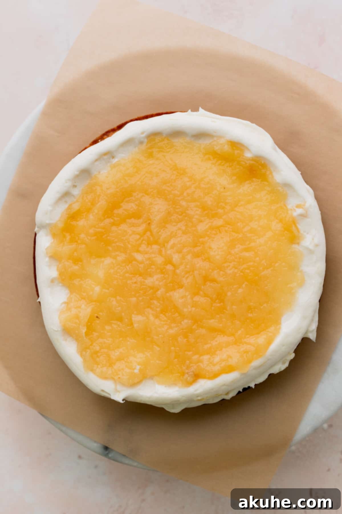 Tropical Pineapple Delight 12 Smooth pineapple jam spread over a layer of frosting on a cake.