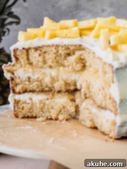 Tropical Pineapple Delight 15 Pineapple sunshine cake cut into on a cake stand, ready to be served.