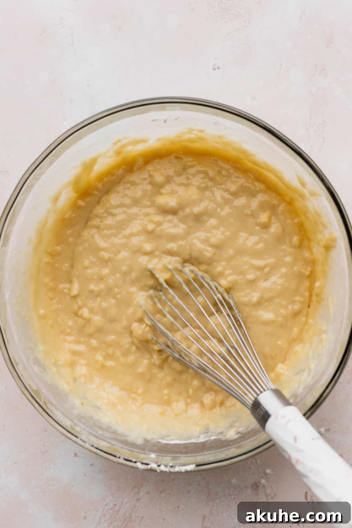 Tropical Pineapple Delight 7 Smooth pineapple cake batter in a clear glass bowl, showcasing its texture.