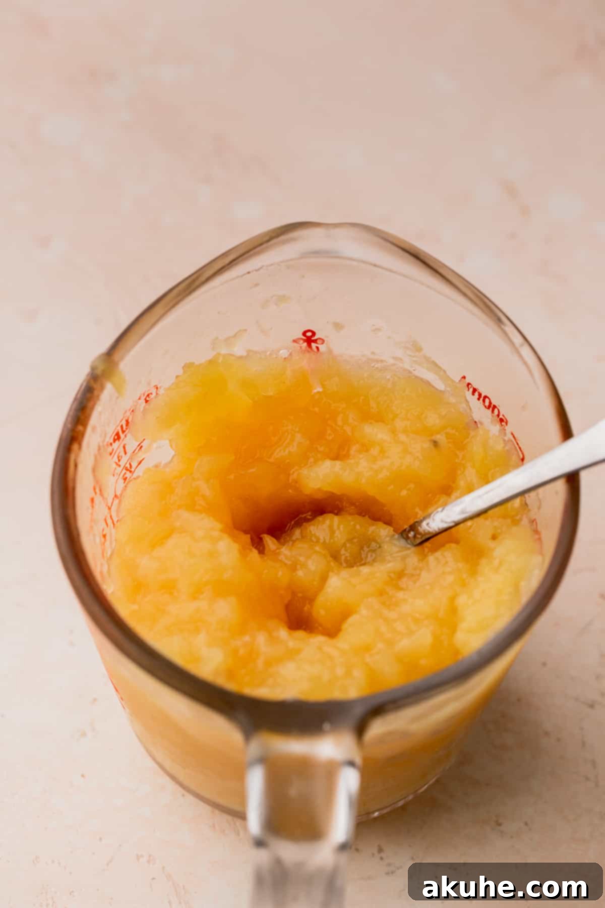 Tropical Pineapple Delight 9 Homemade pineapple jam cooling in a glass measuring cup, ready for assembly.