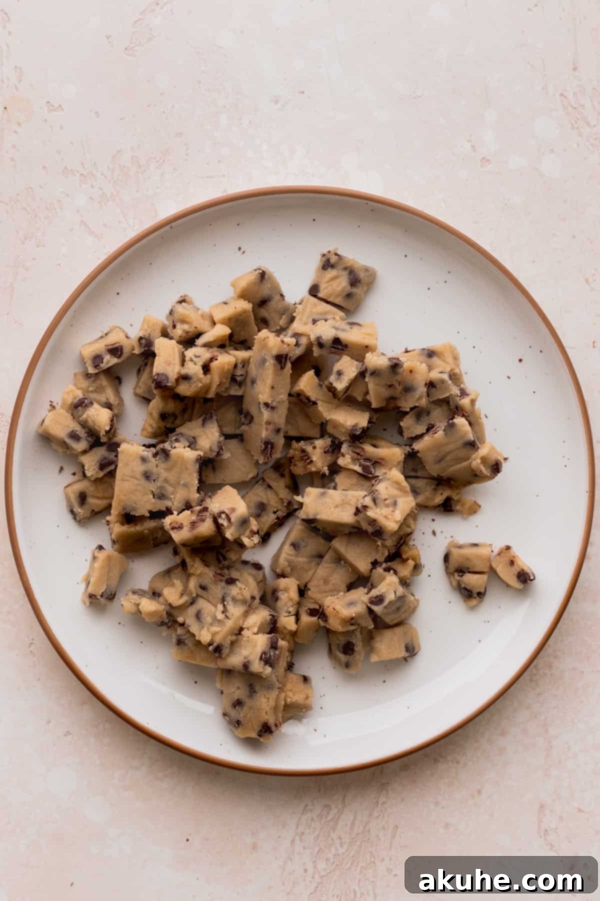 Ultimate Cookie Dough Ice Cream Cake 10 Small, bite-sized pieces of edible cookie dough neatly arranged on a plate.