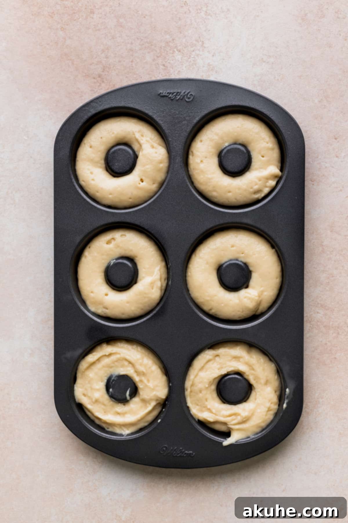 Glazed Strawberry Treats 6 Donut cake batter in a donut pan.