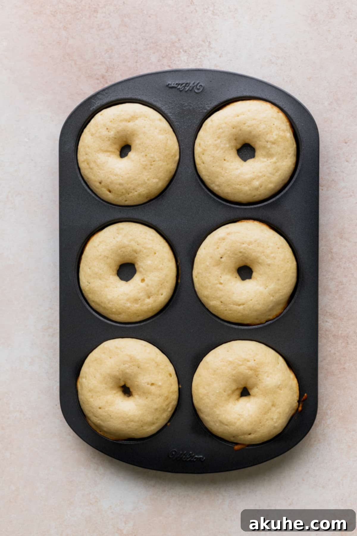 Glazed Strawberry Treats 7 Donuts baked in donut pan.