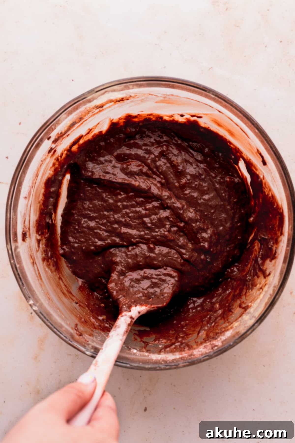 Decadent Double Chocolate Banana Bread 5 Lush double chocolate banana bread batter resting in a clear glass bowl, ready for baking.